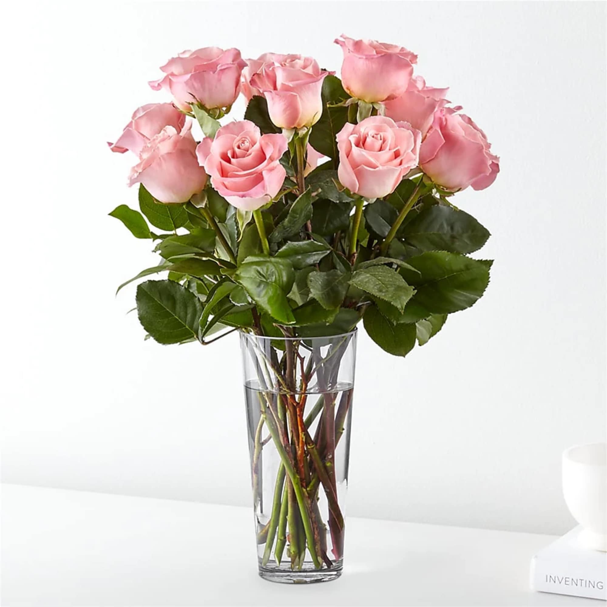 Pink roses arranged in a clear glass vase