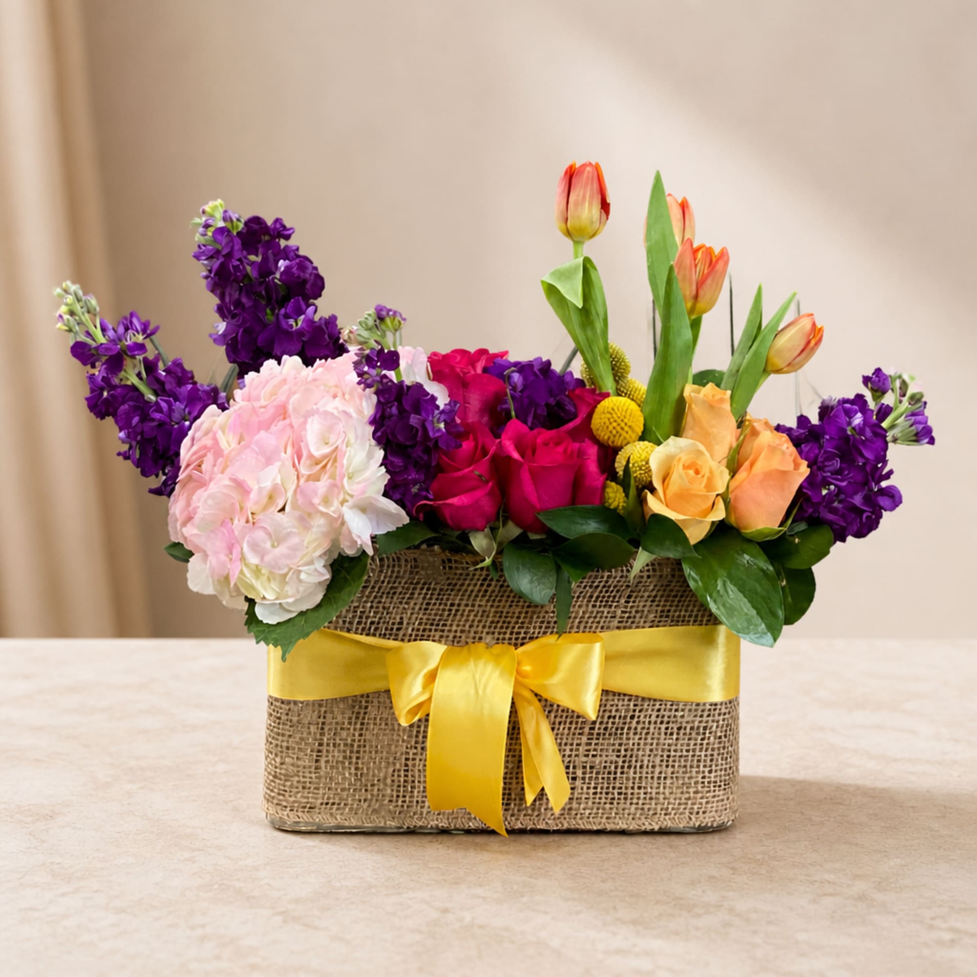 Mixed bouquet in a burlap box with a yellow ribbon