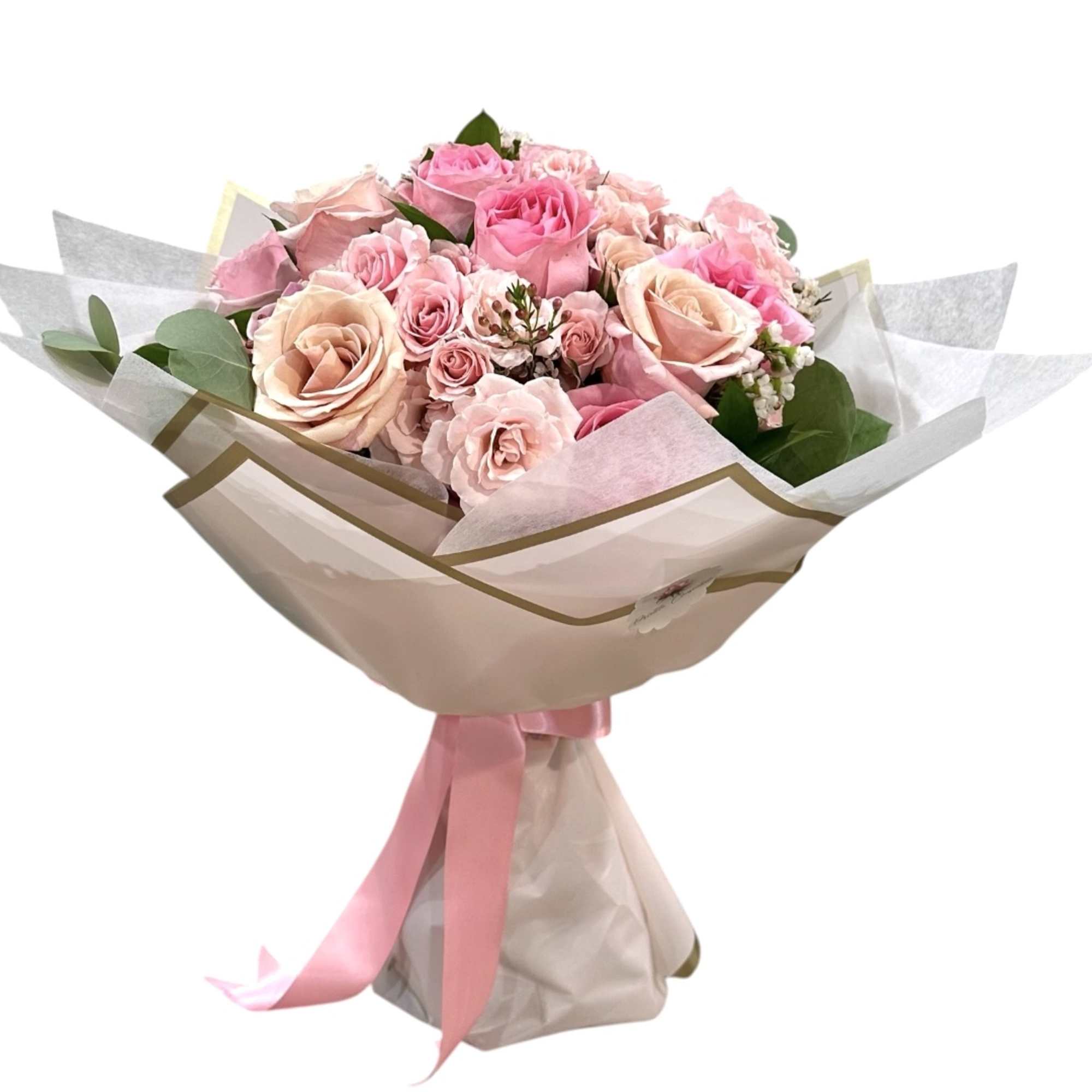Bouquet of pink roses wrapped in pale paper with a pink ribbon