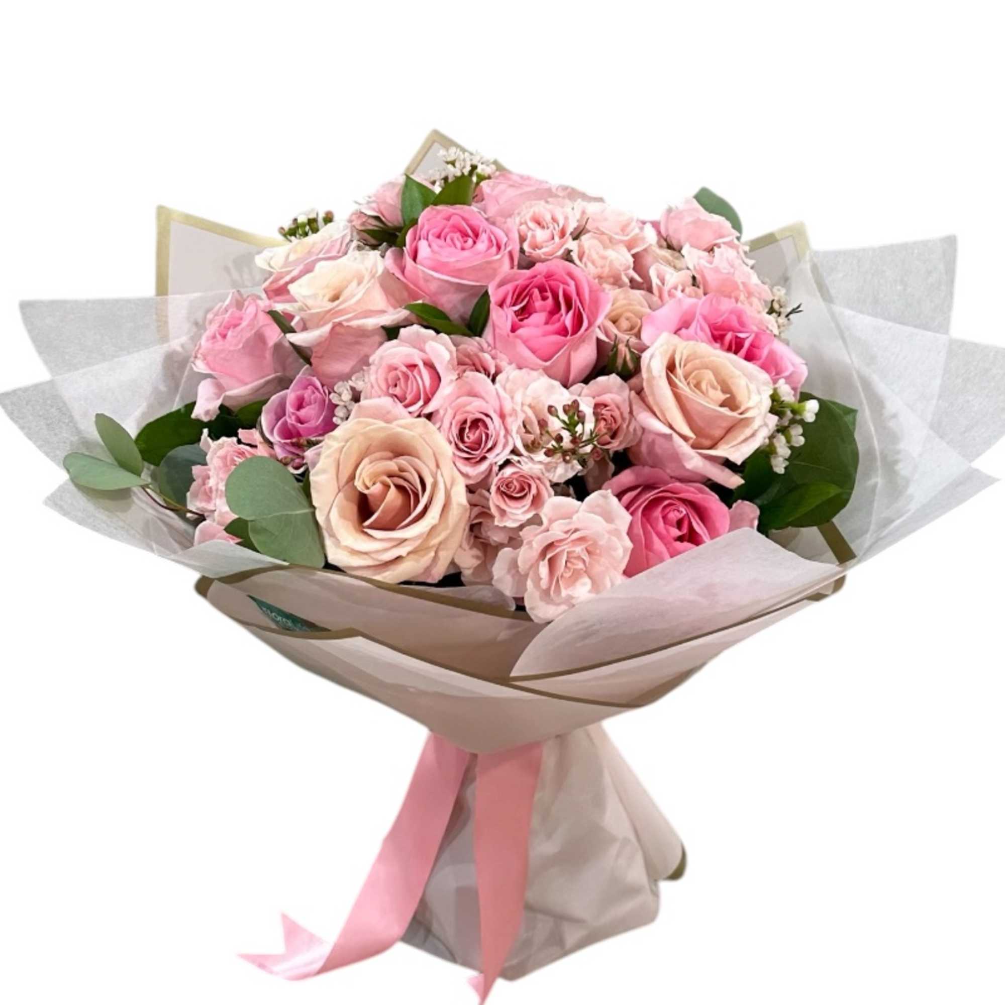 Bouquet of pink and peach roses wrapped in paper with a pink ribbon