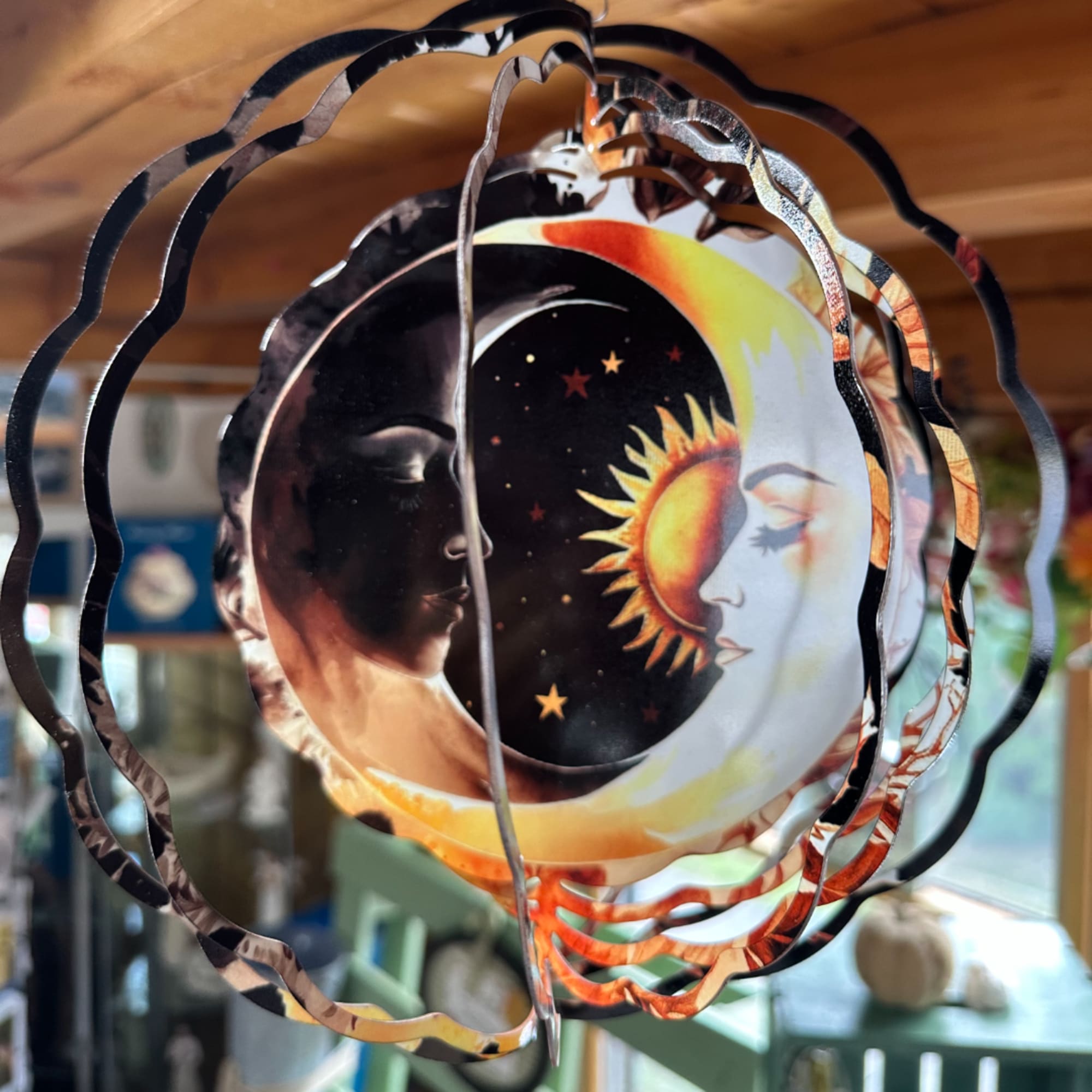 Decorative hanging mobile with a sun-and-moon face design