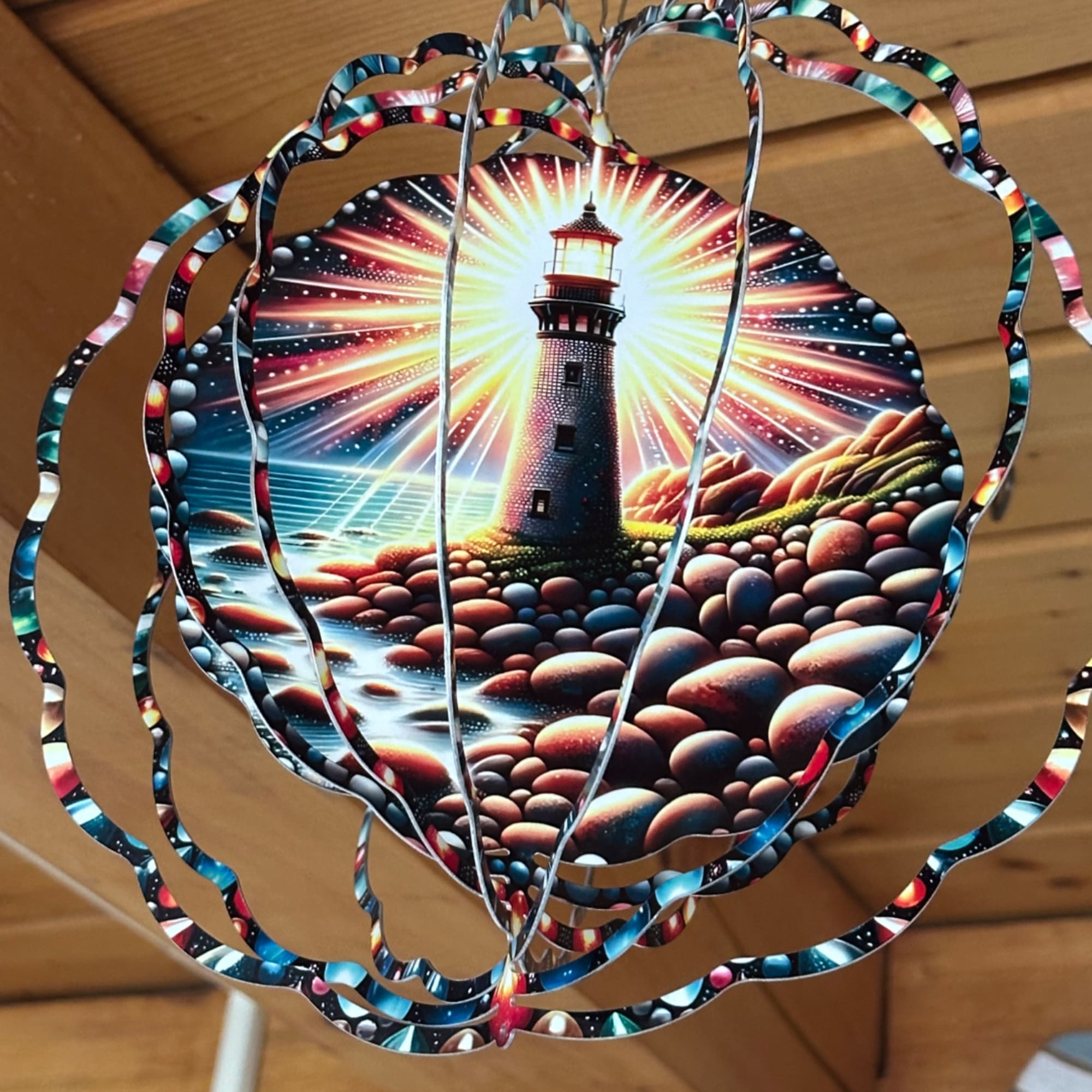 Decorative hanging paper lantern with a lighthouse scene
