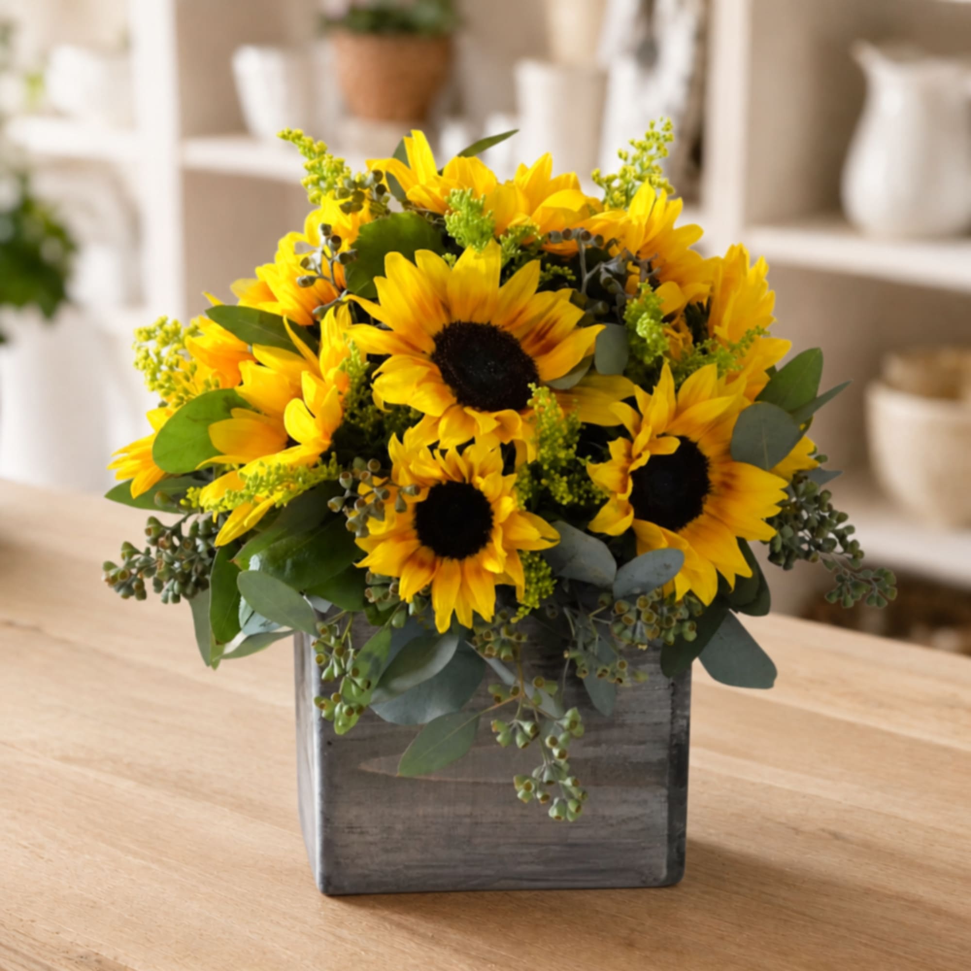 Sunflower arrangement in a gray wooden box