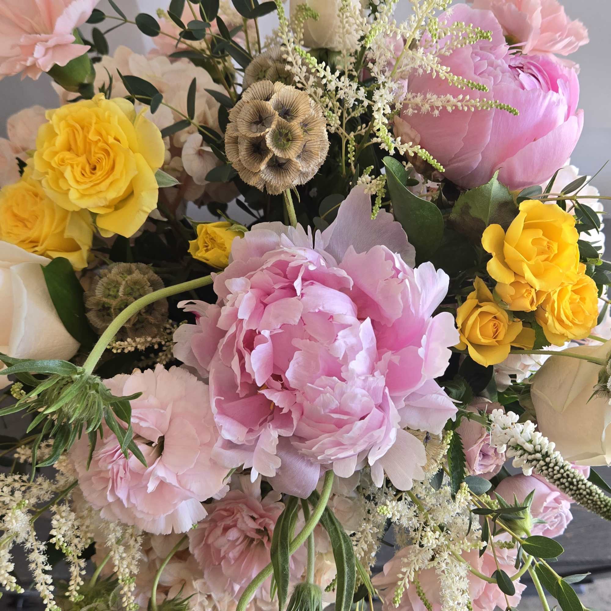 A mix of summer flowers surrounding gorgeous blooming peonies., photo 2 of 3