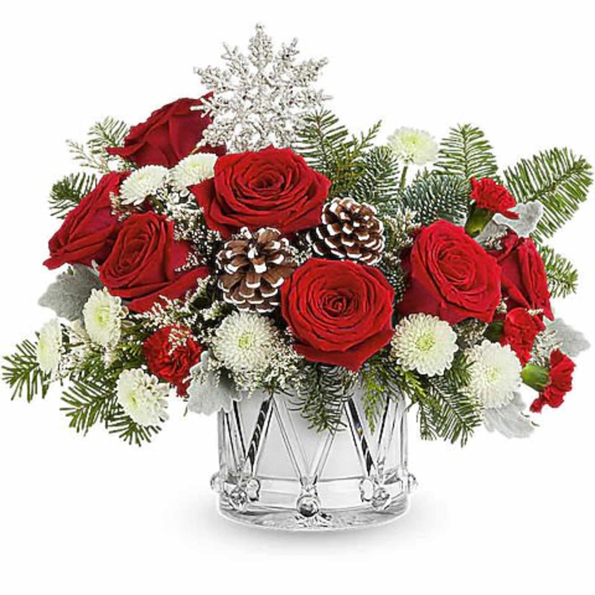 Red roses and white flowers arranged in a clear glass vase