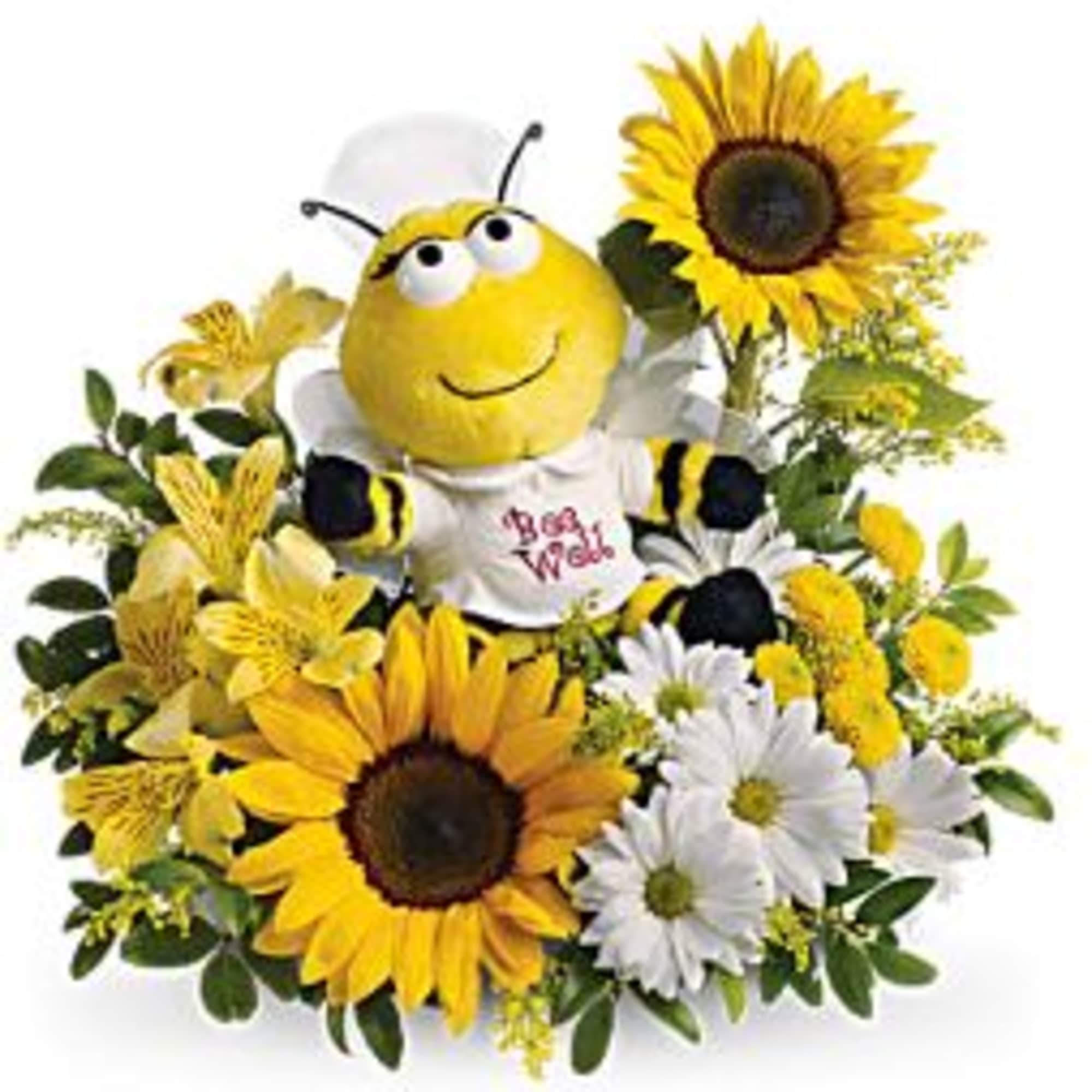 Bee plush surrounded by sunflowers and white daisies