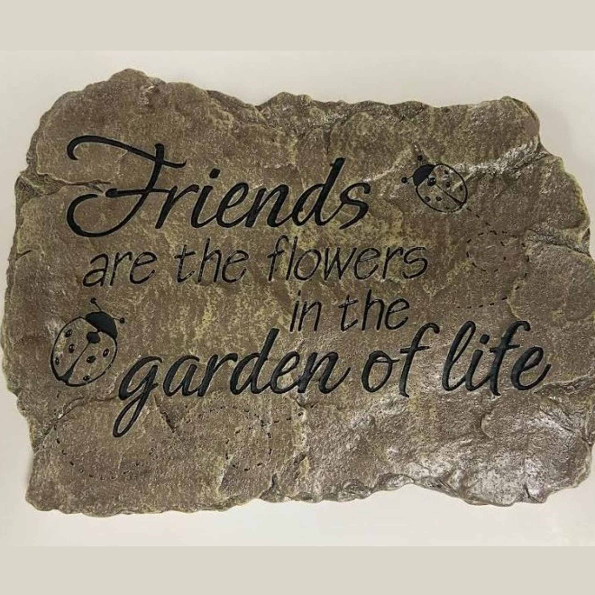 Decorative stone plaque with the quote "Friends are the flowers in the garden of life"