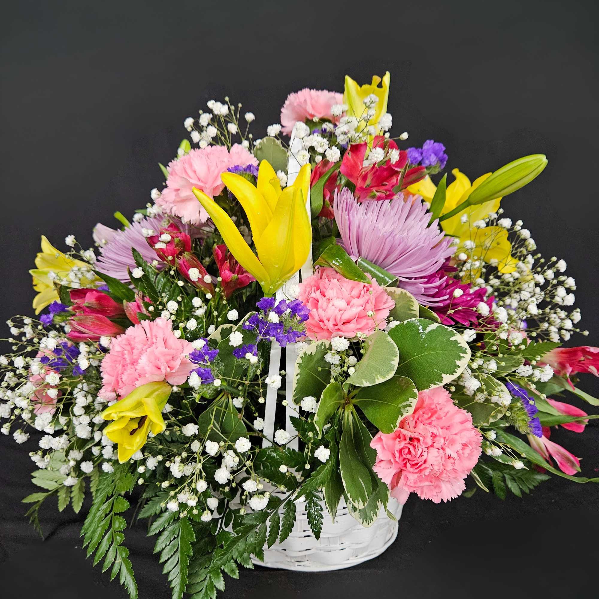 A basket of bright, colorful flowers to pick up anyone's spirits. Includes