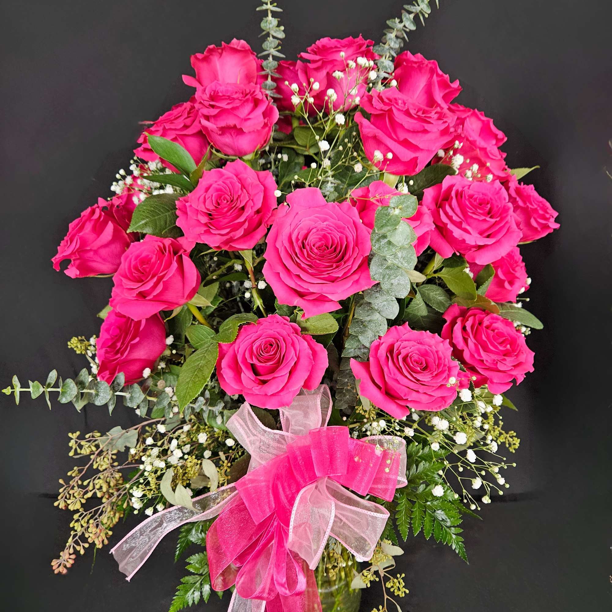 Bouquet of bright pink roses with a pink ribbon bow