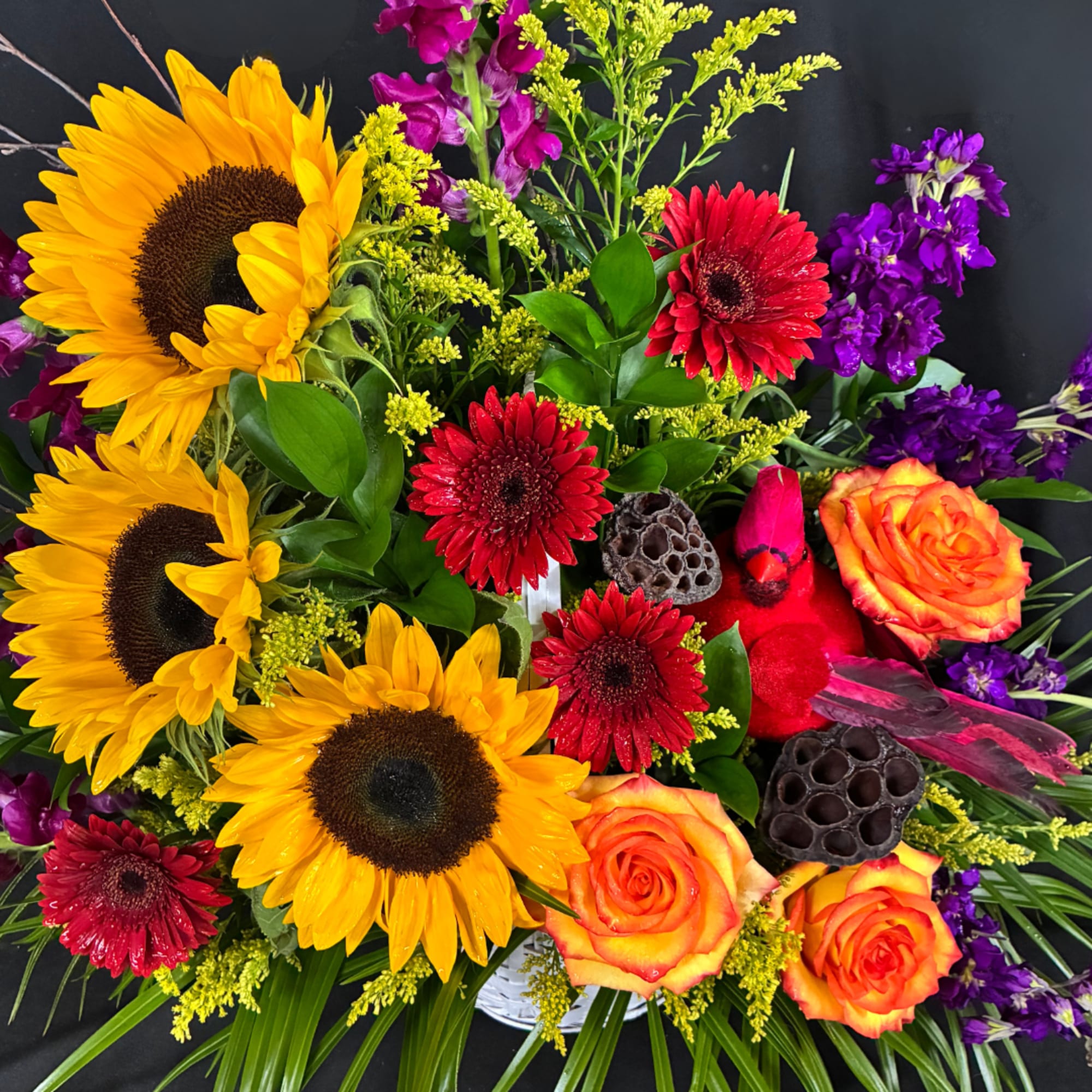 Bright mixed bouquet with sunflowers, red gerberas, and orange roses