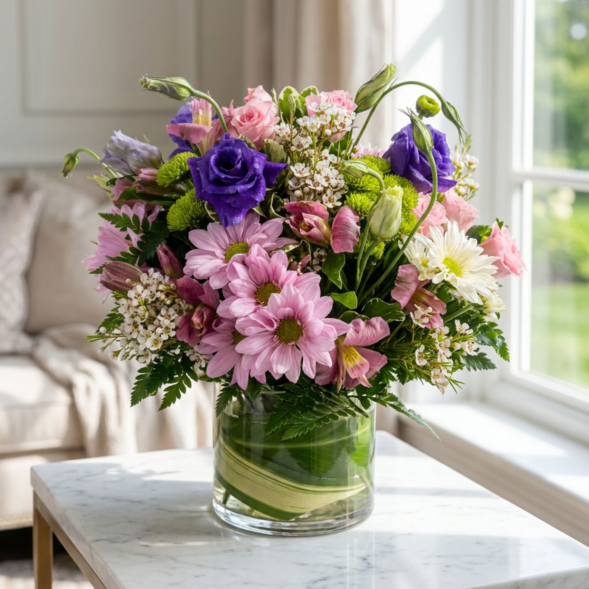 Mixed pink and purple bouquet in a clear glass vase