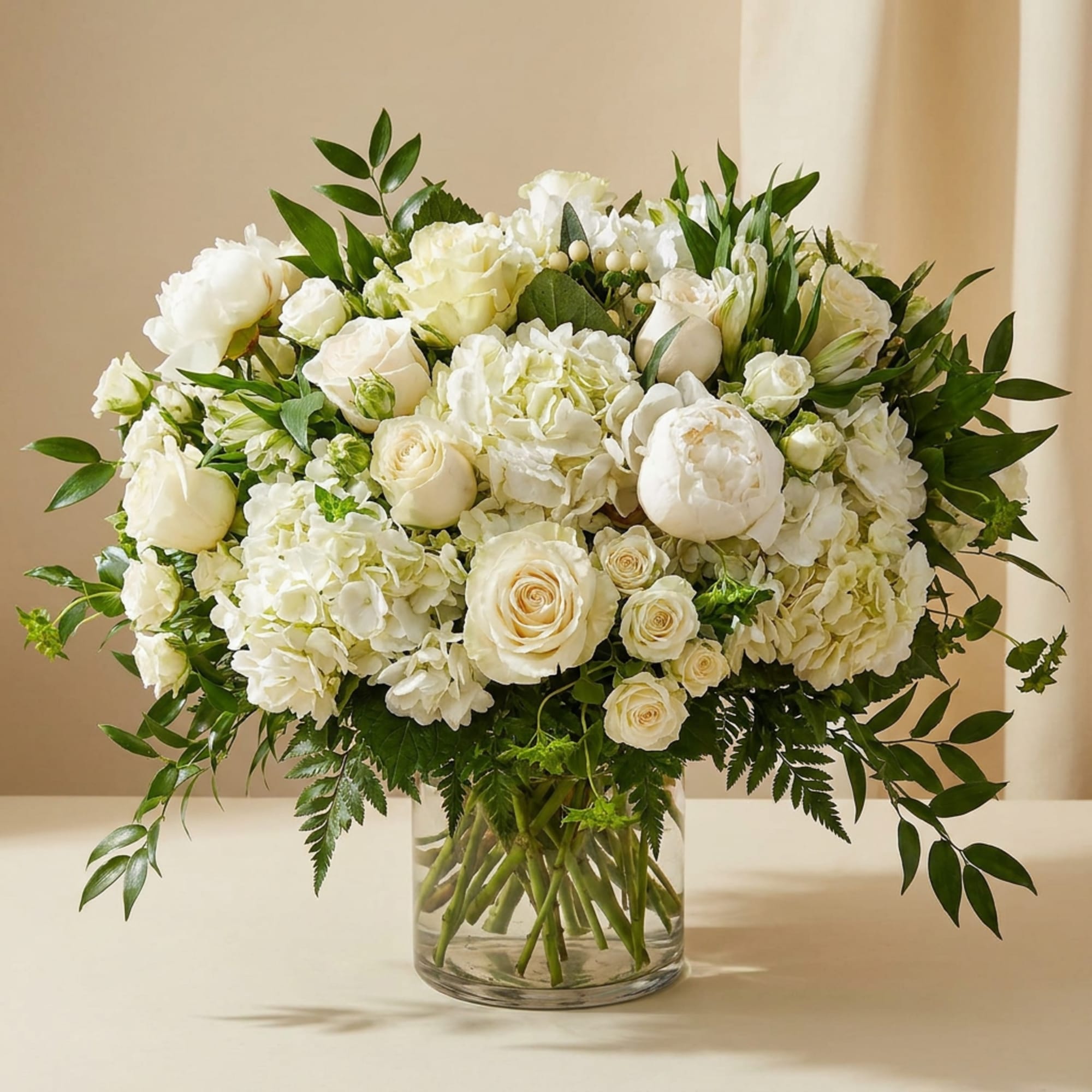 White rose and hydrangea bouquet in a clear glass vase