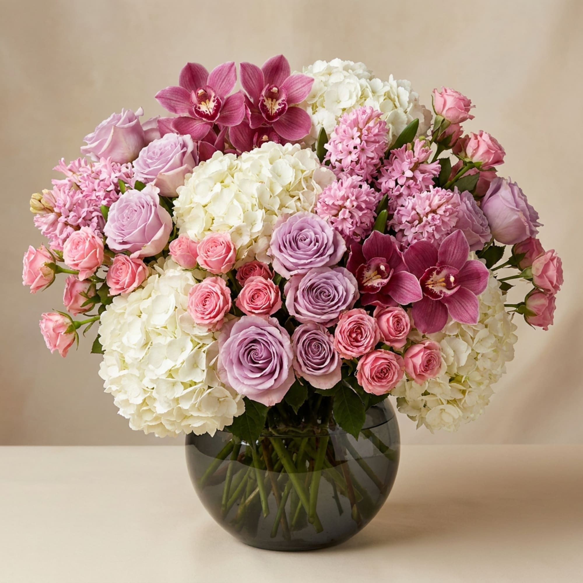 Pink and white floral arrangement in a dark glass vase