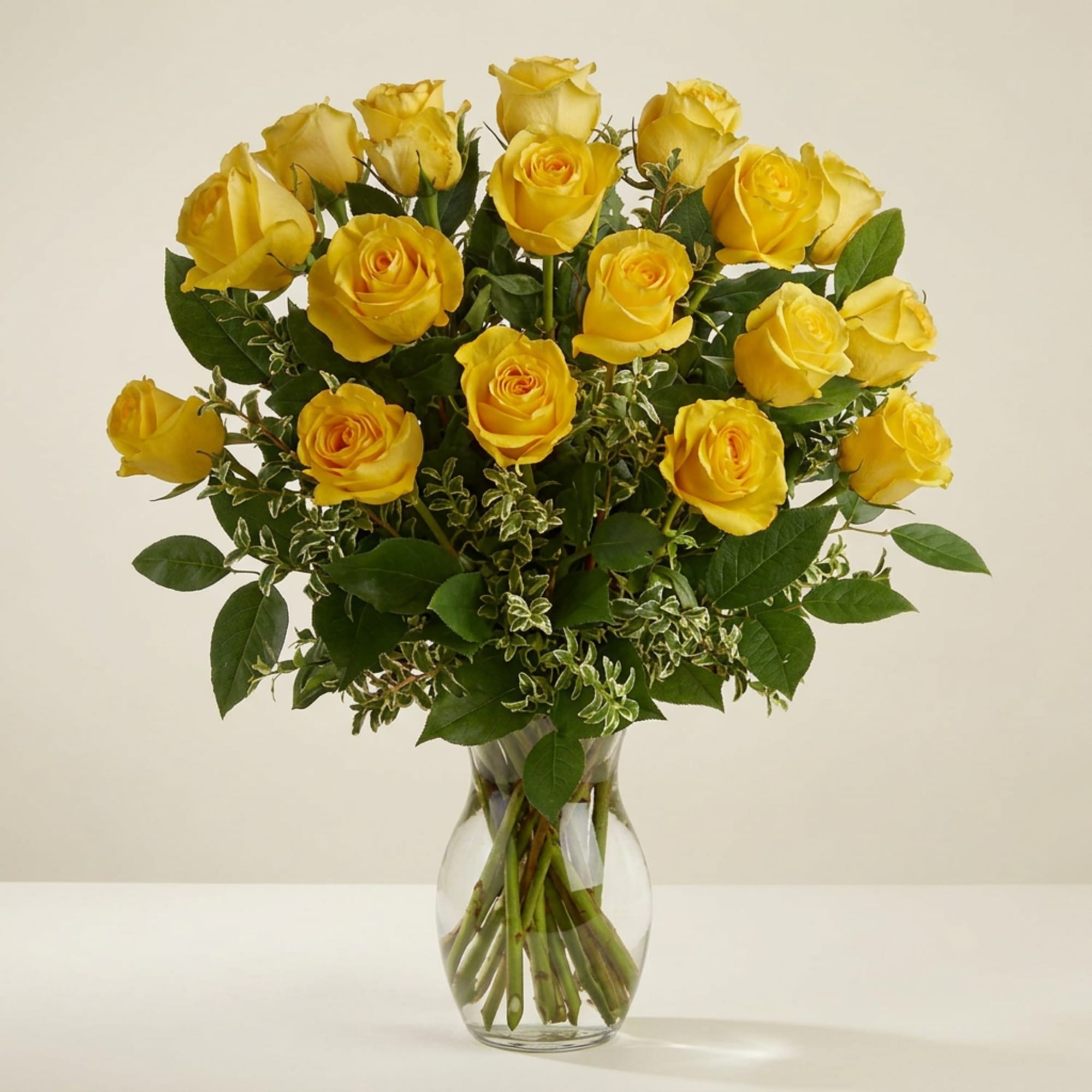 Yellow roses arranged in a clear glass vase