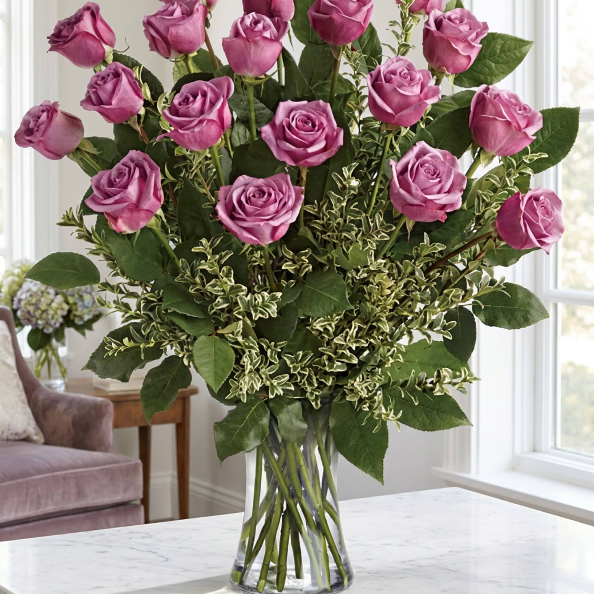 Pink roses arranged in a clear glass vase