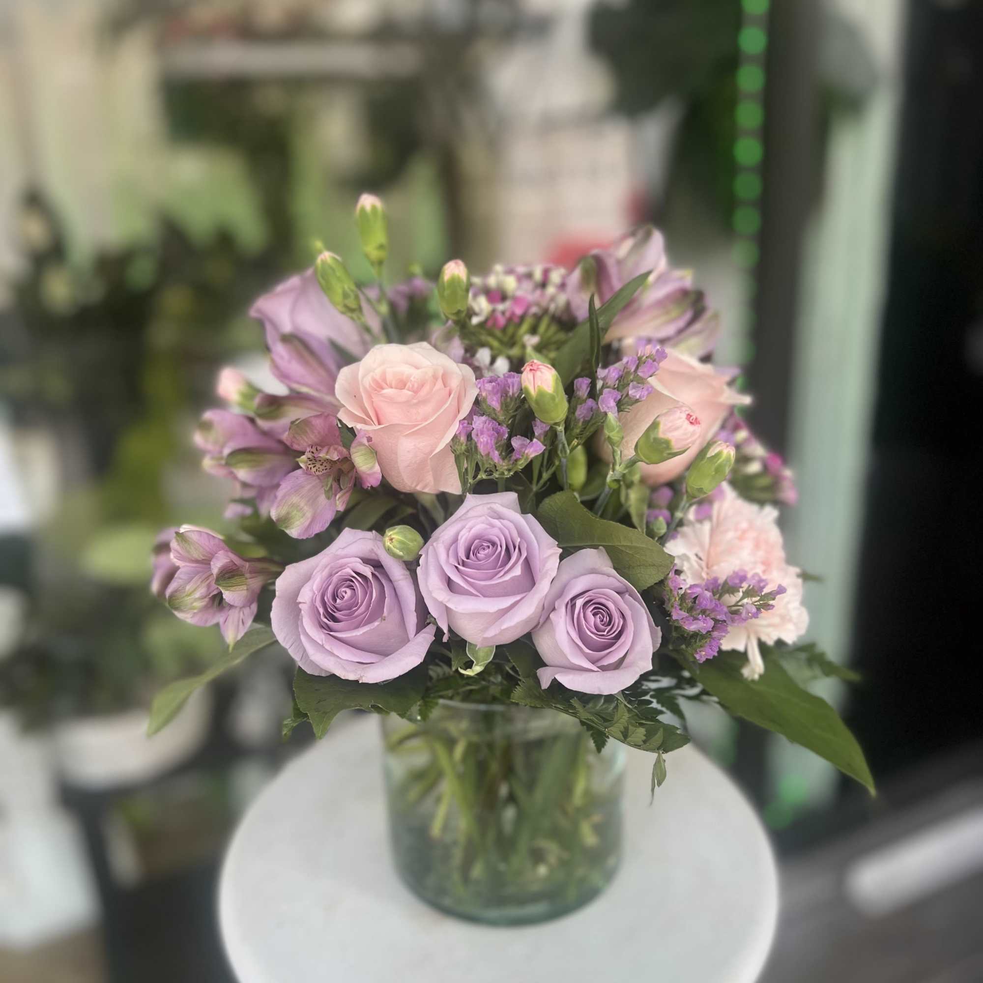 Lavender and pink rose bouquet in a glass vase