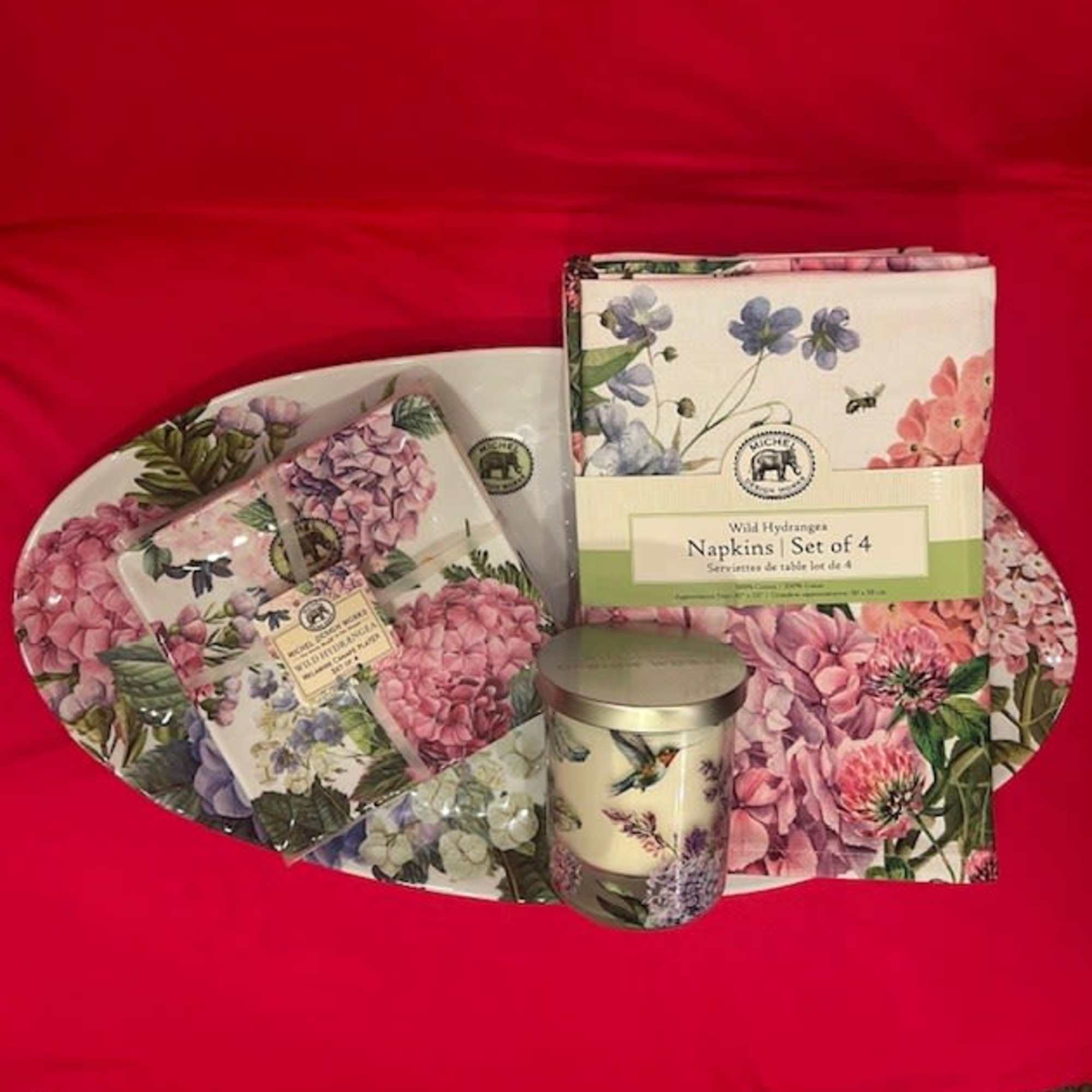 Floral-patterned napkins and a candle arranged on a tray