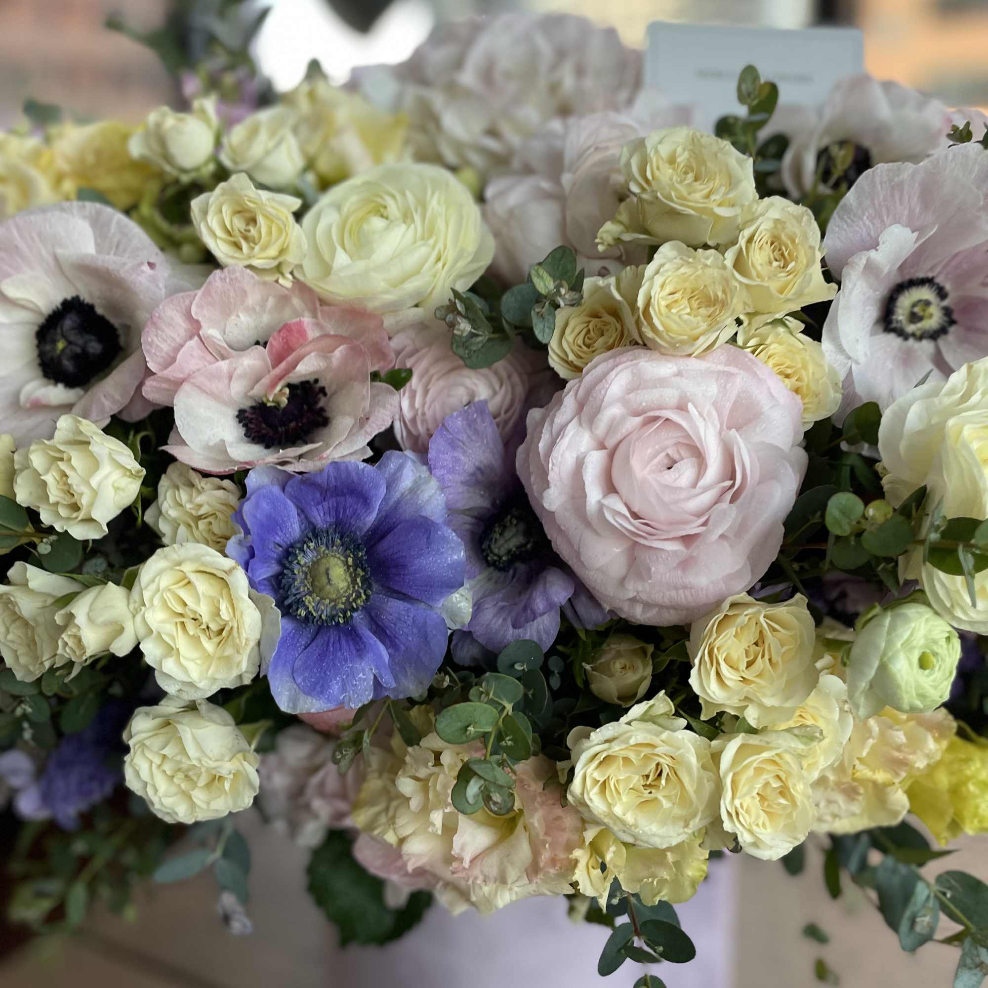 Bouquet of pale roses and anemones in soft pastel colors