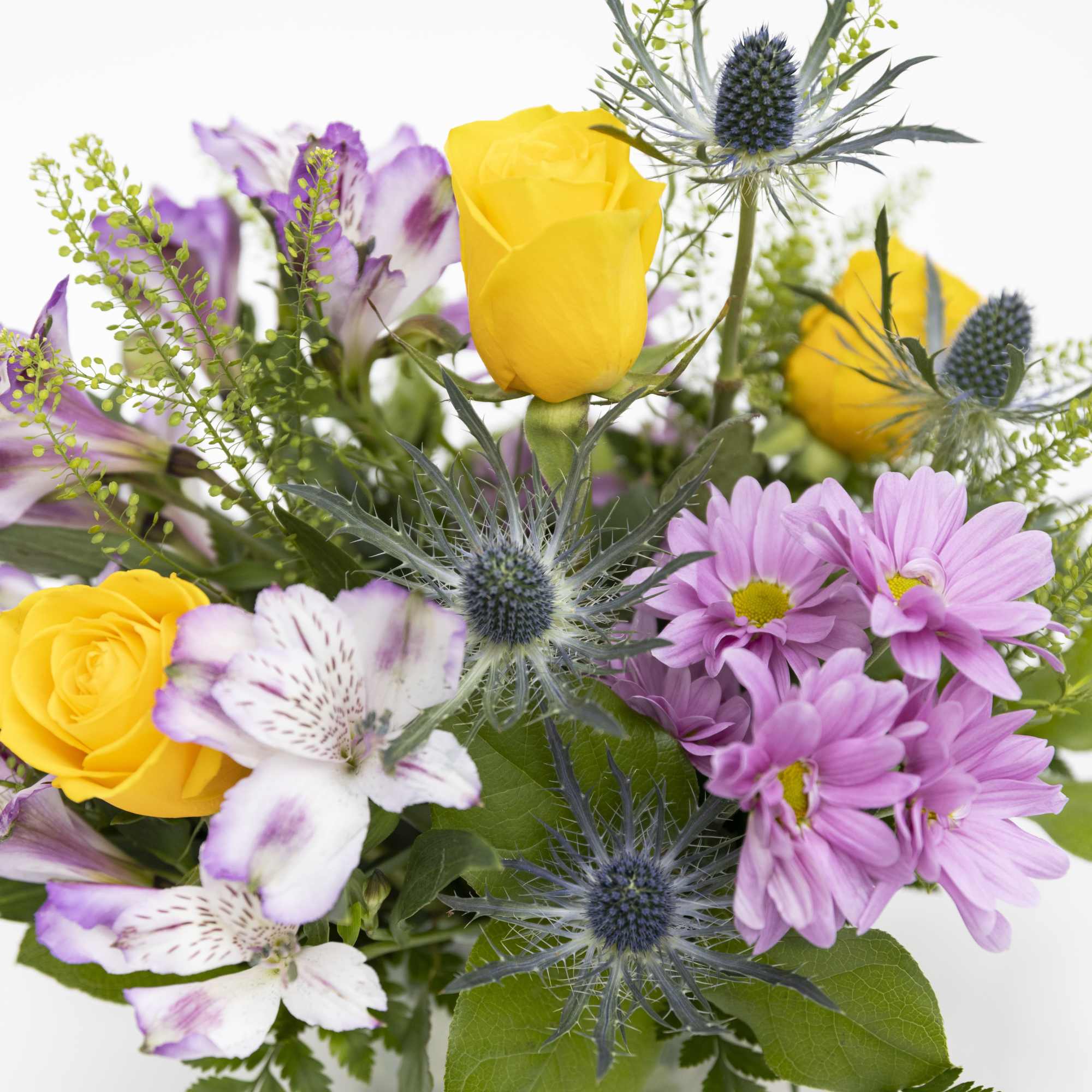 Bright bouquet with yellow roses, pink daisies, white and purple alstroemeria, and spiky blue accent blooms