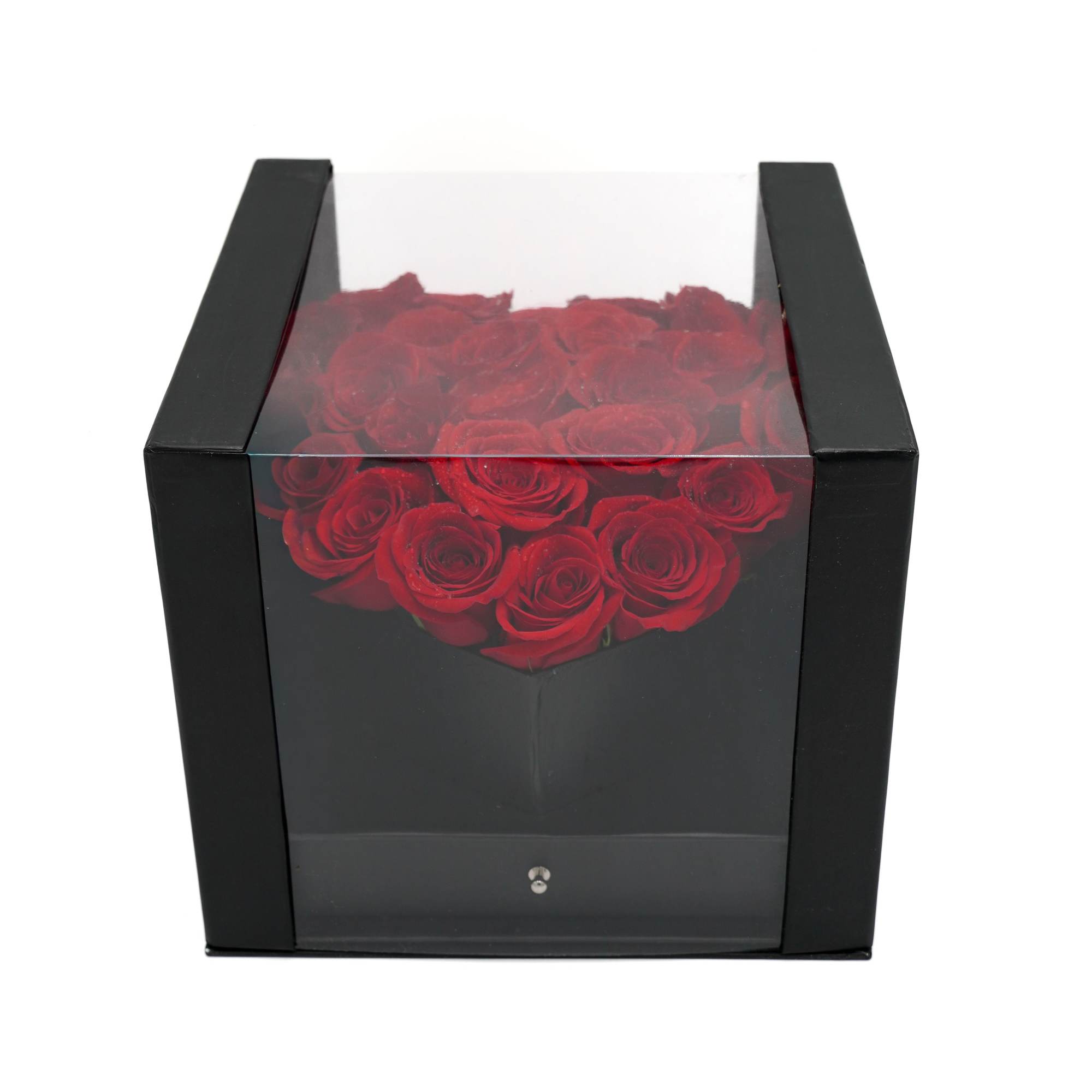 Red roses arranged in a black square gift box with a clear lid