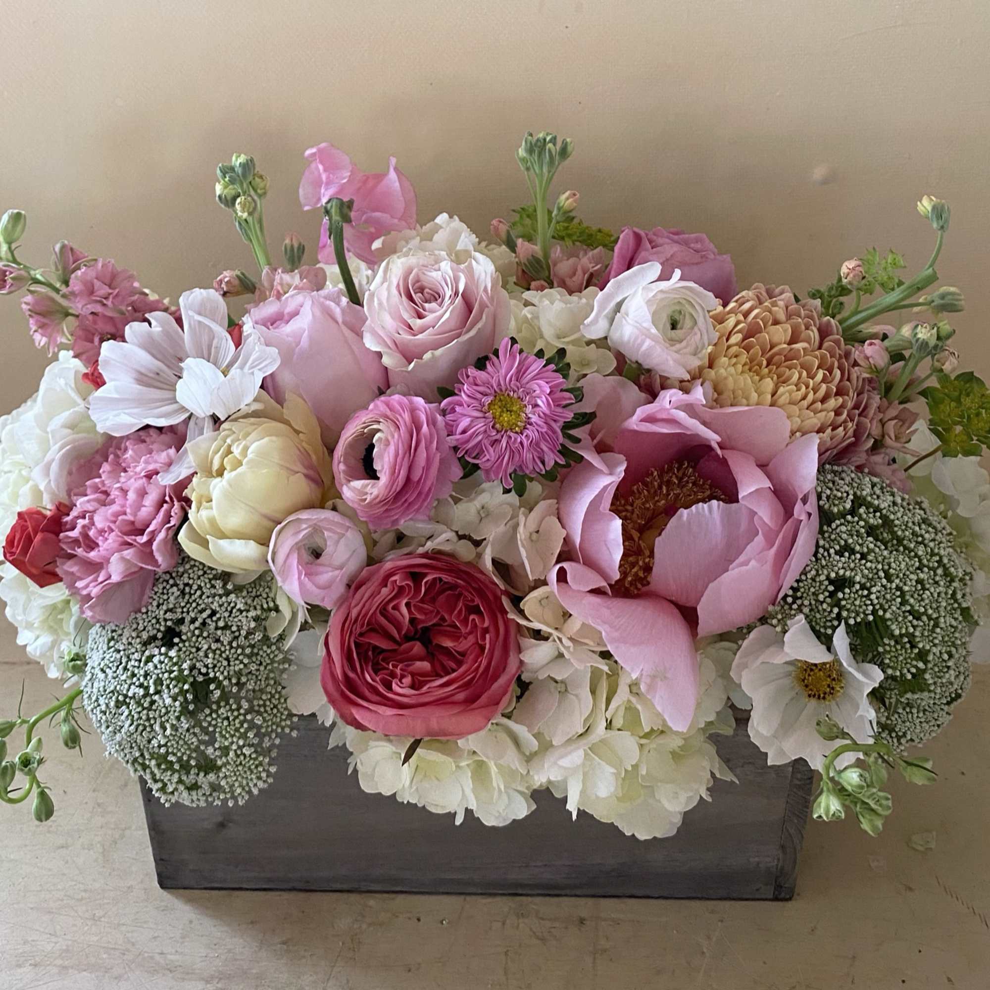 Pink and white mixed flower arrangement in a rectangular wooden box