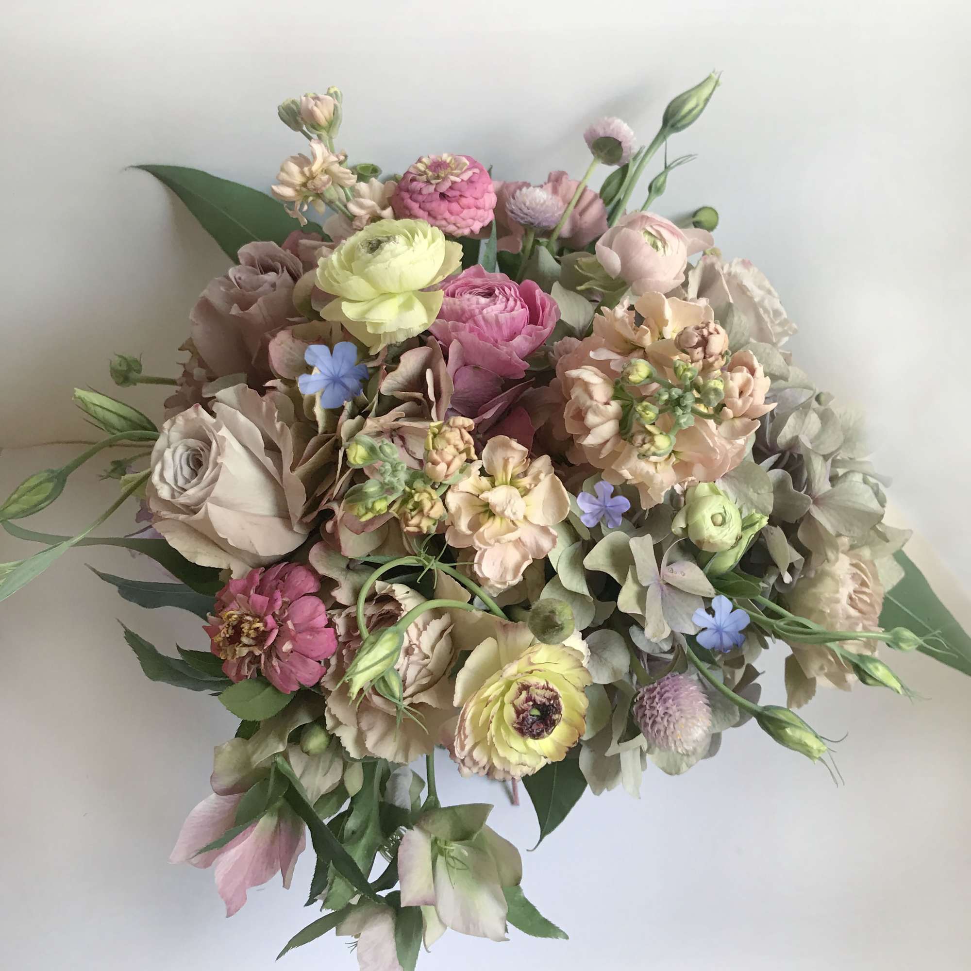 Pastel bouquet with pink, cream, and yellow flowers