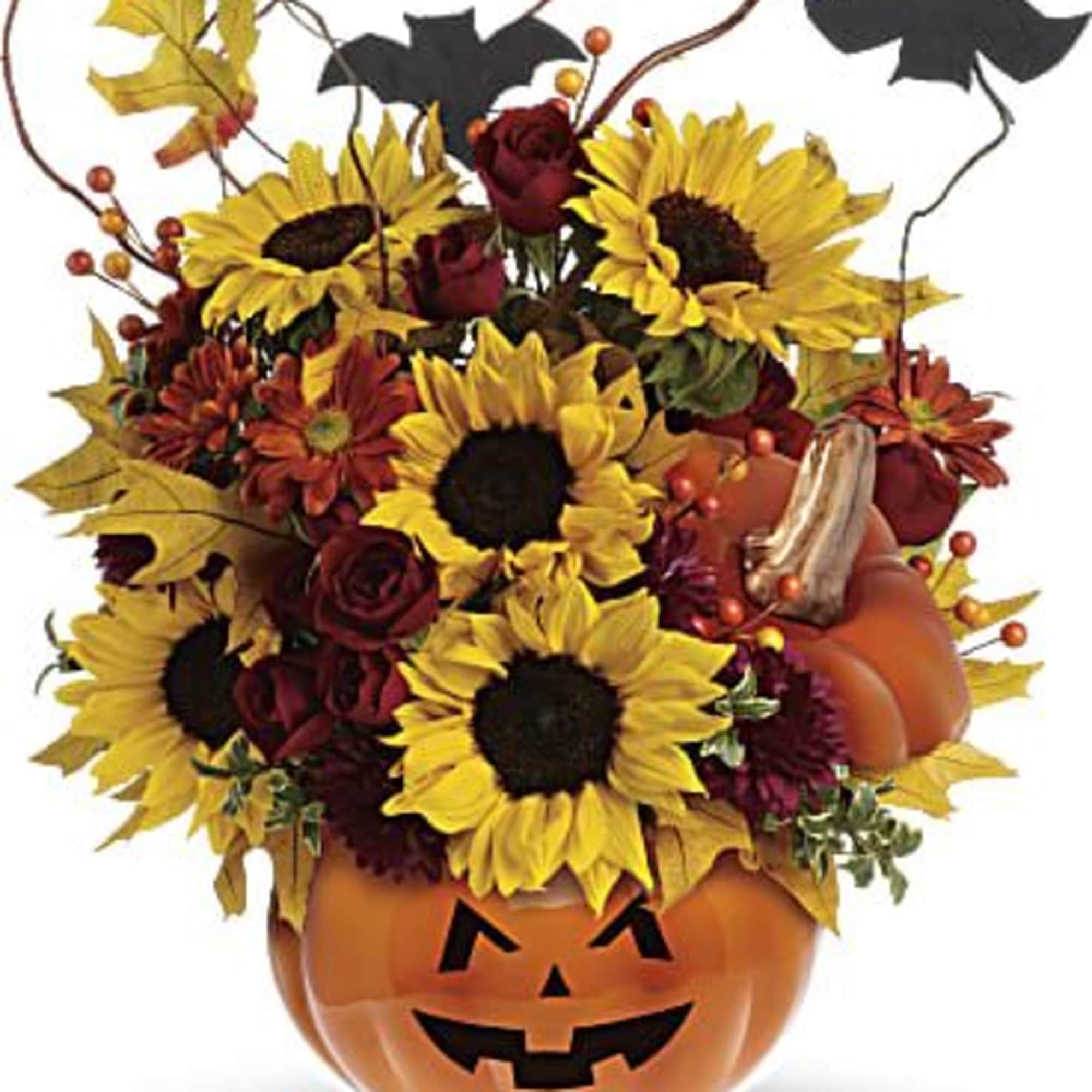 Sunflowers and red roses arranged in a jack-o'-lantern pumpkin container
