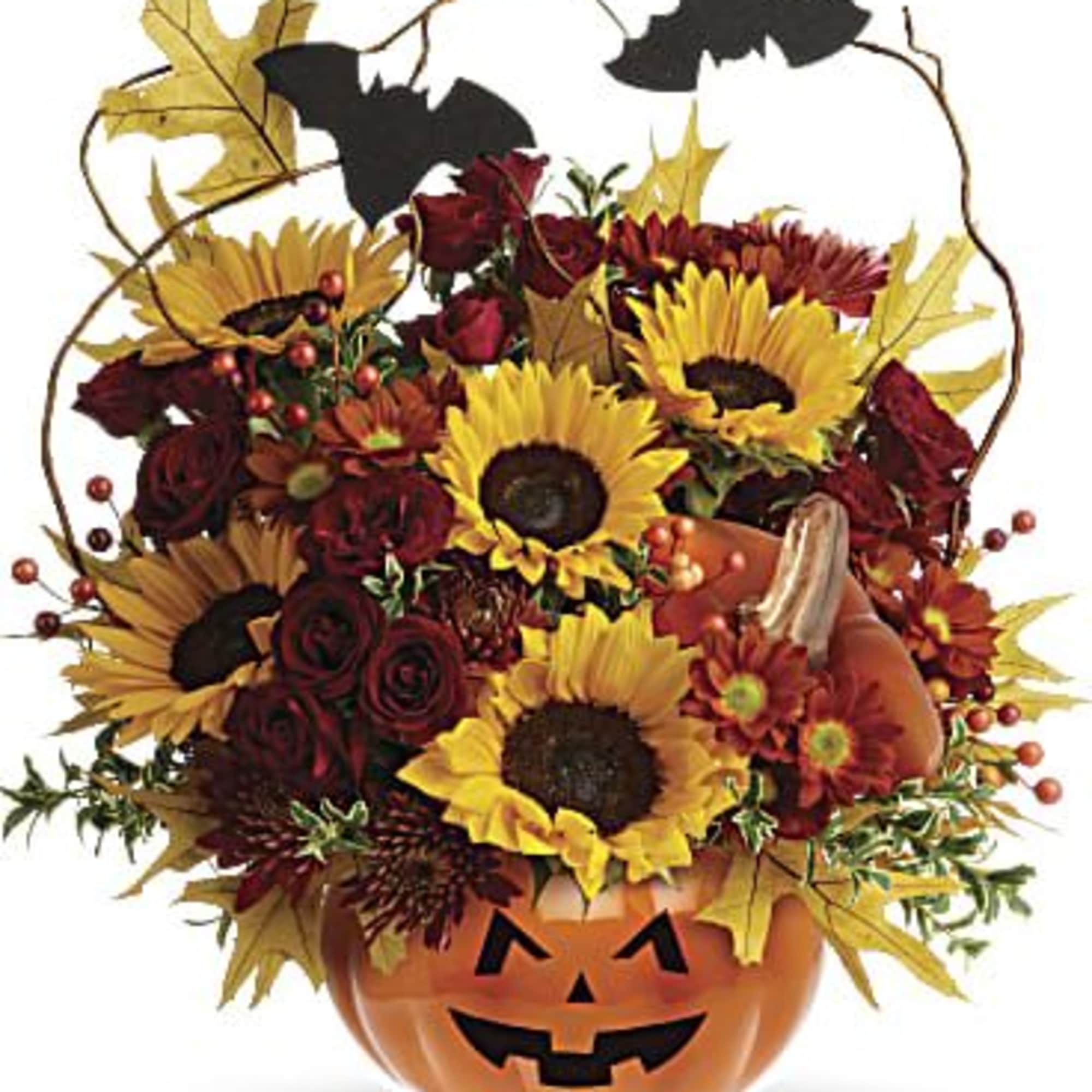 Halloween bouquet in a jack-o'-lantern container with sunflowers and red roses