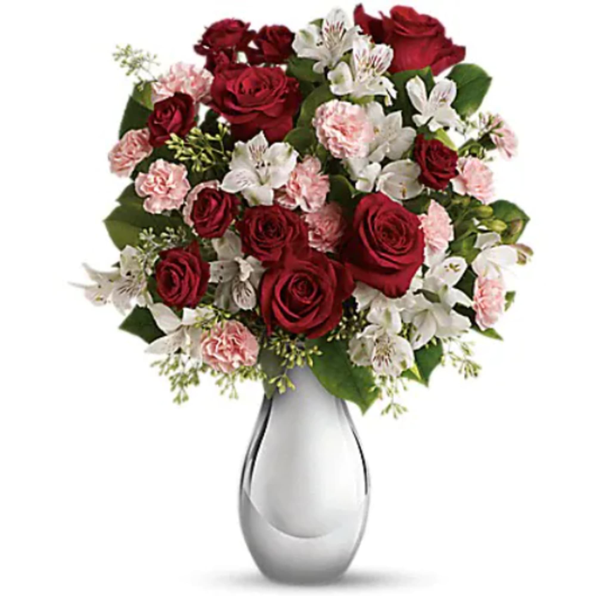 Red roses and pink-white flowers in a clear glass vase