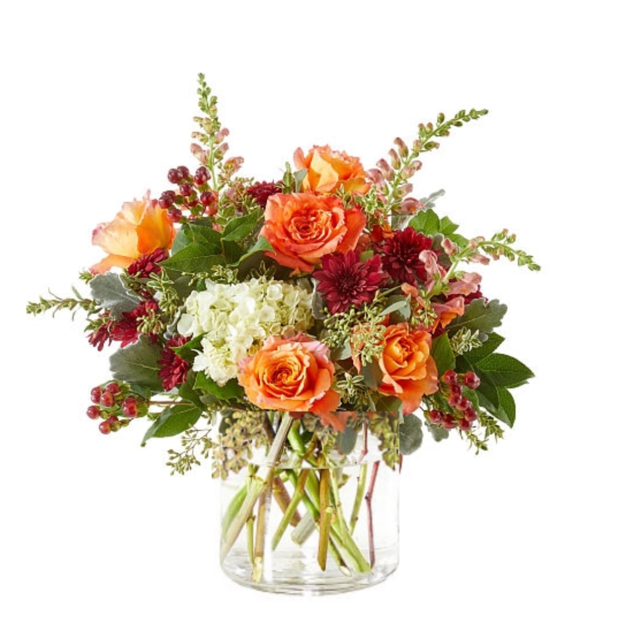 Orange and burgundy flower arrangement in a clear glass vase