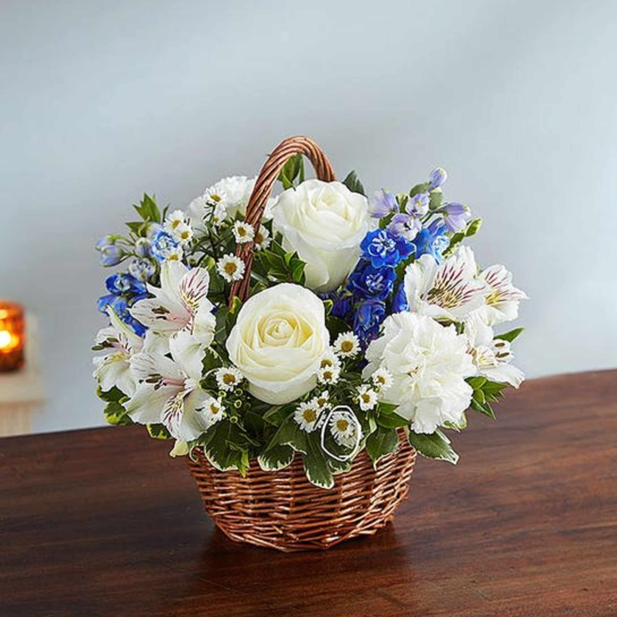 Basket of white roses and mixed blue-white flowers