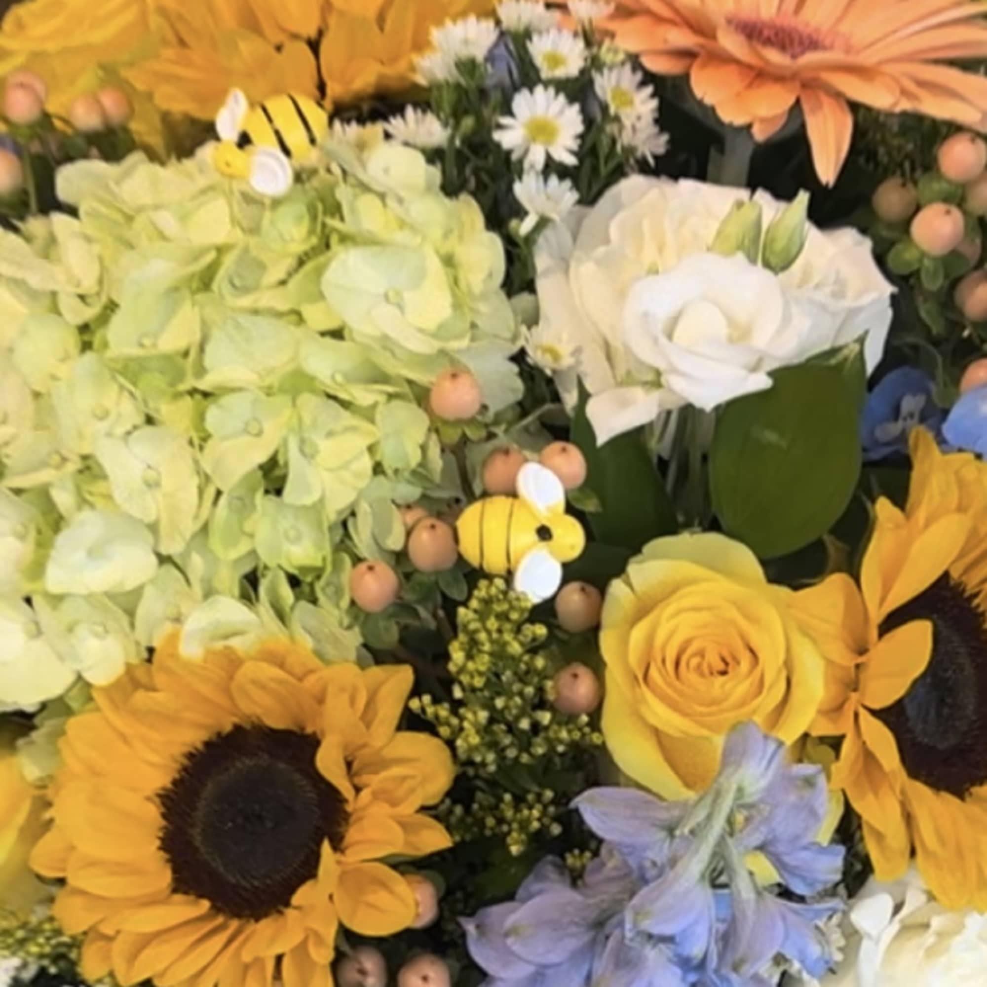 Mixed bouquet with sunflowers, hydrangeas, roses, and daisies