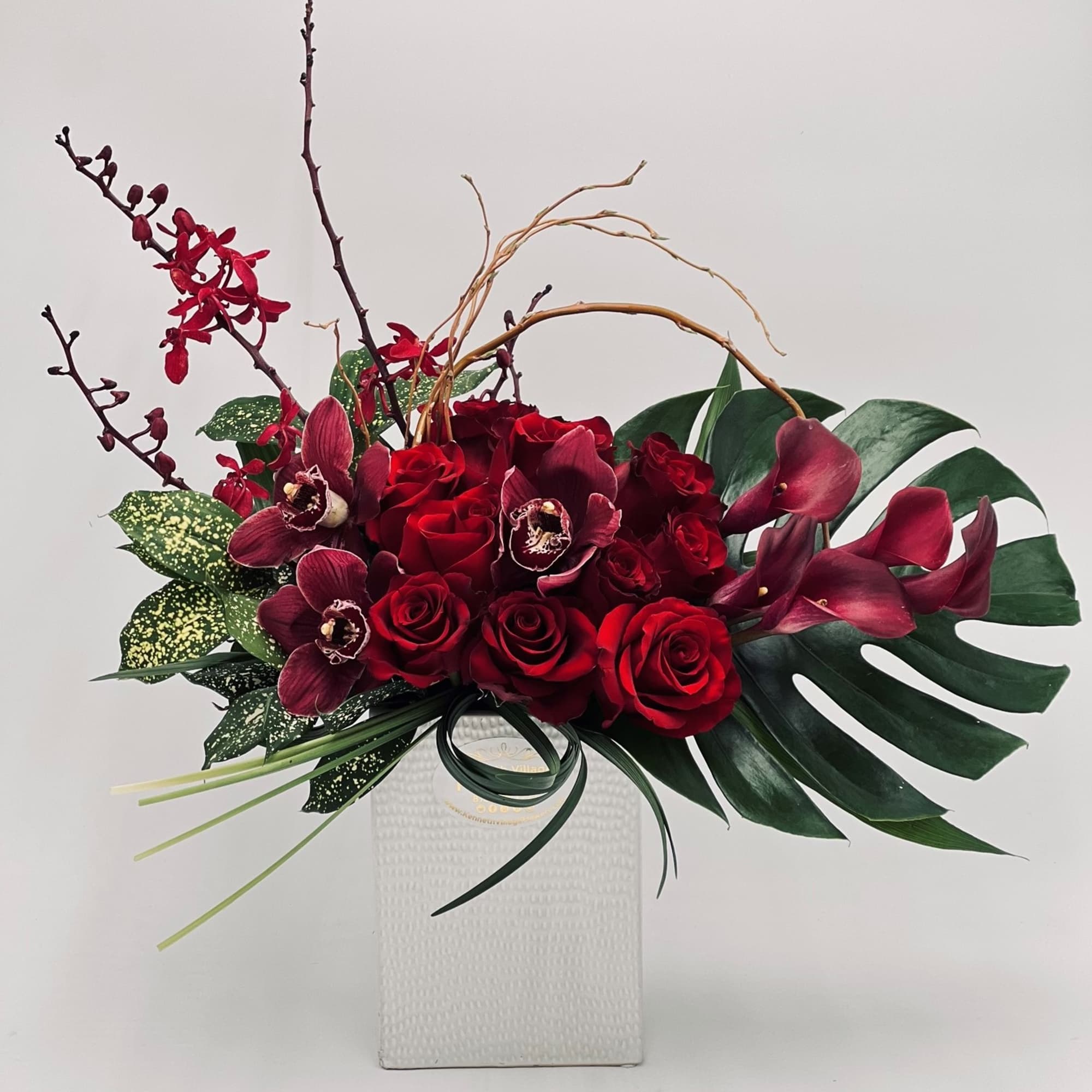 Red roses and burgundy orchids in a white vase, photo 2 of 3
