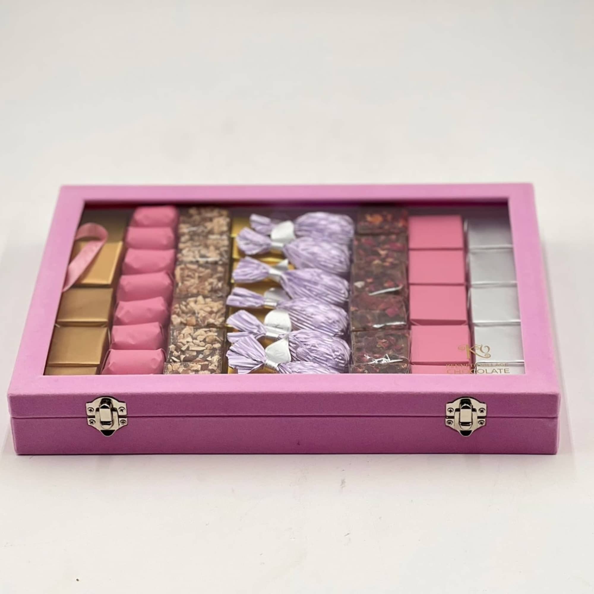 Pink gift box filled with assorted chocolates and wrapped sweets