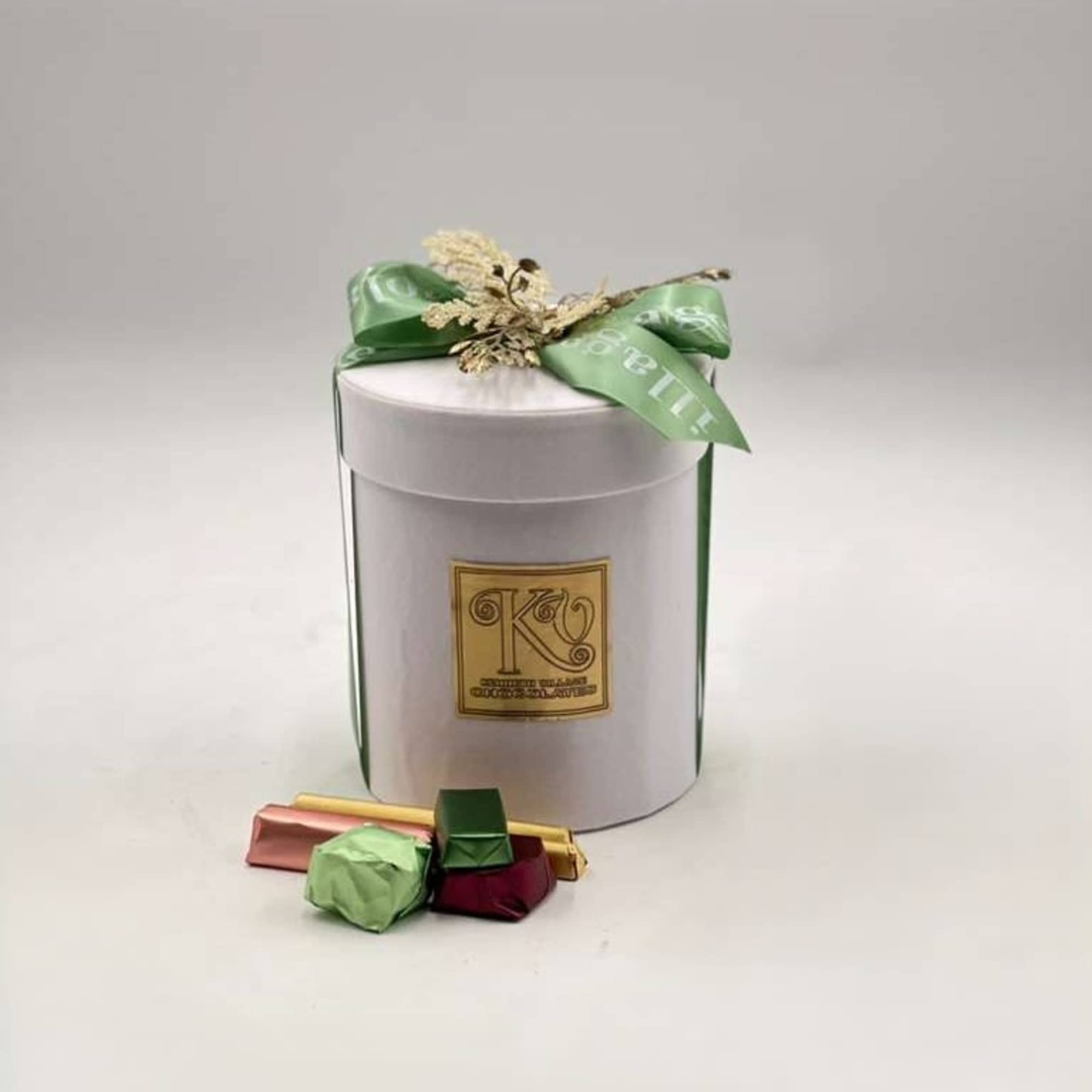 Gift box with chocolates and a green ribbon bow