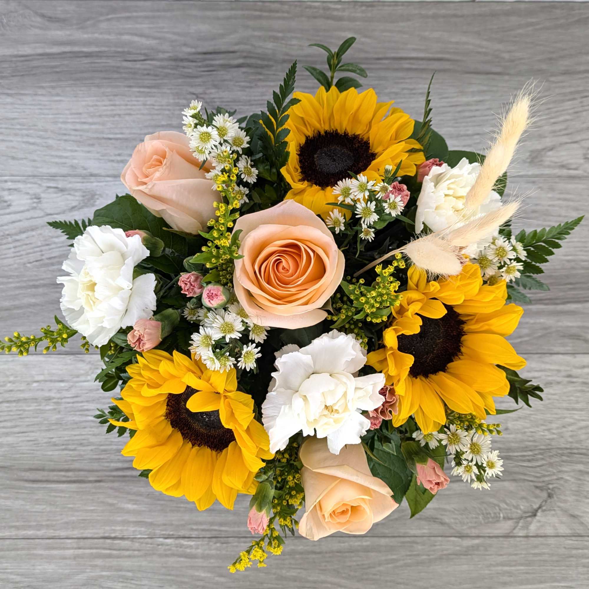 Bouquet with sunflowers, peach roses, and white carnations
