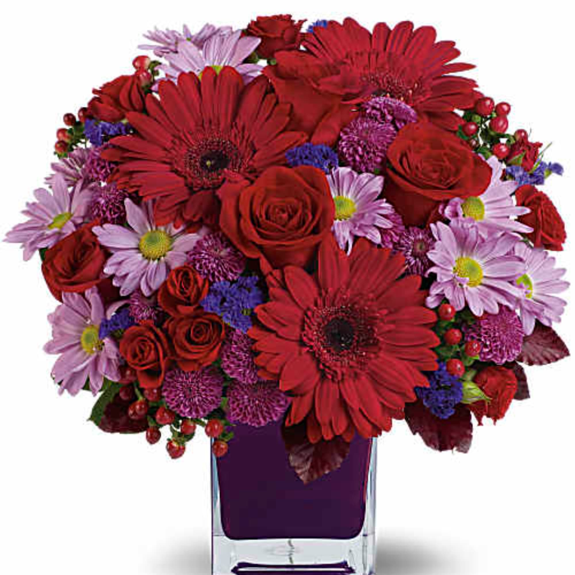 Red roses and daisies in a purple glass vase