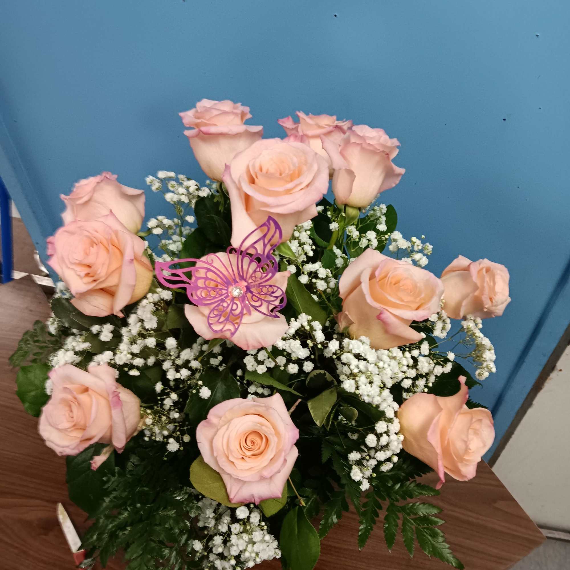 Soft peach-pink roses gathered in a rounded, upright bouquet create a tender, photo 2 of 3