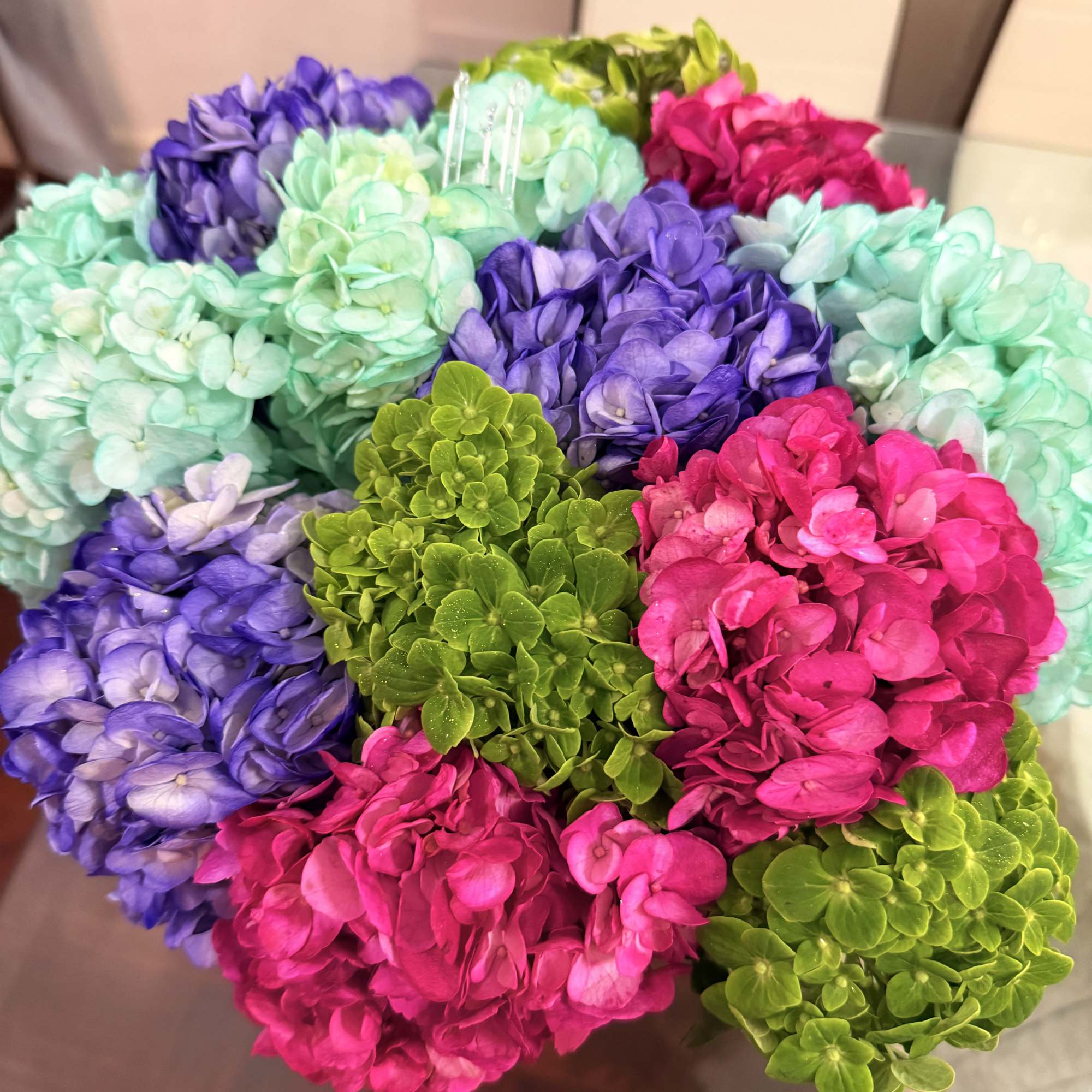 Colorful hydrangea bouquet in pink, purple, aqua, and green