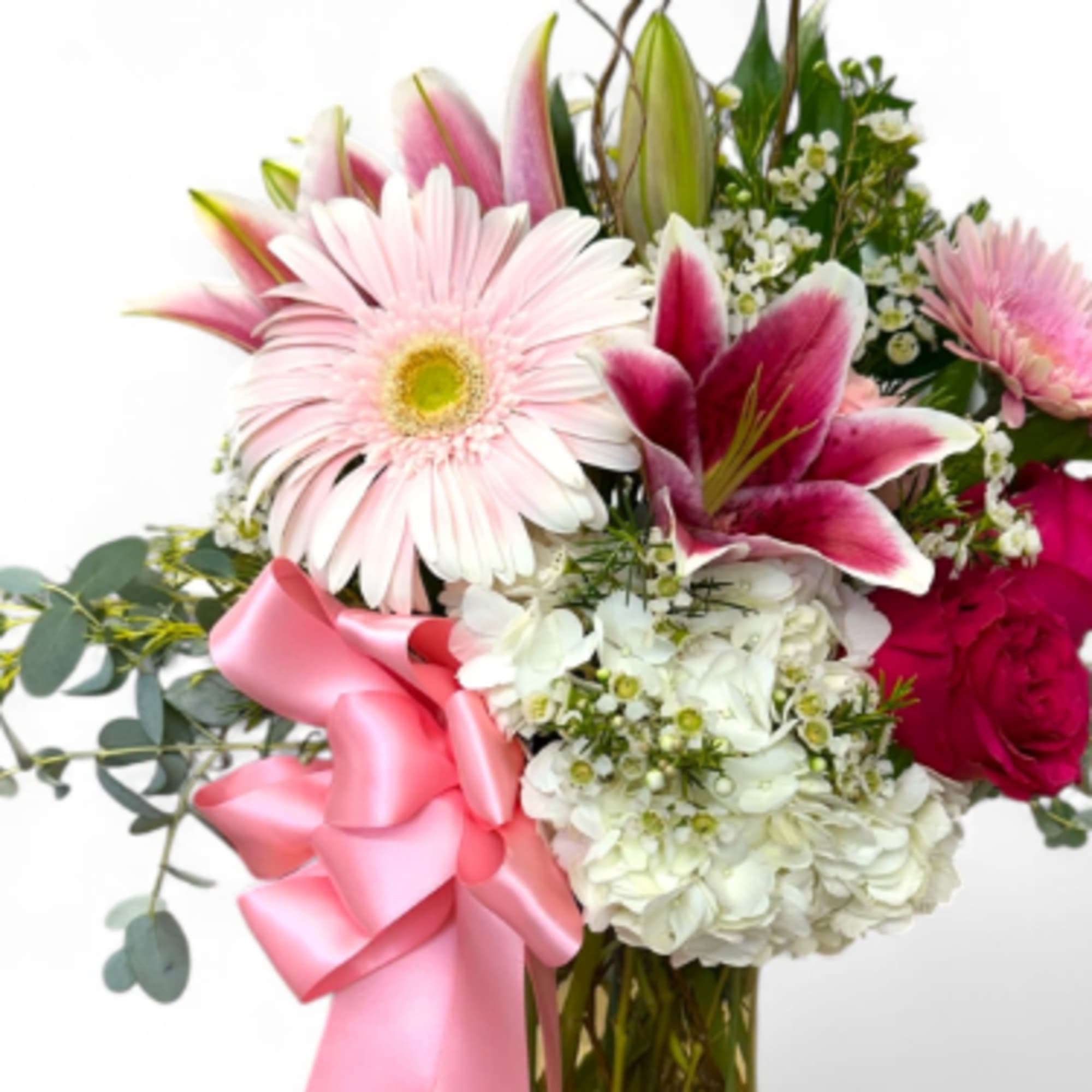 Pink and white bouquet with lilies, gerbera daisies, hydrangea, and a pink ribbon