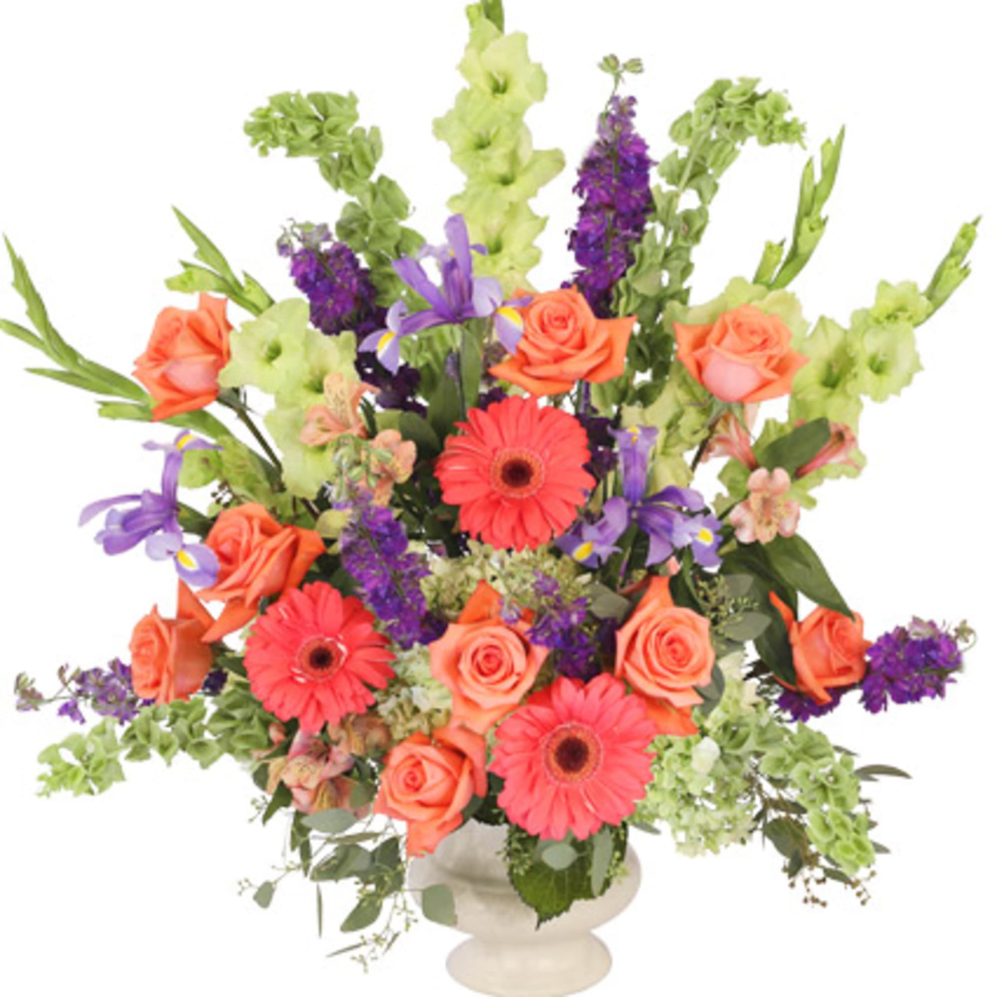 Colorful mixed flower arrangement in a white pedestal vase