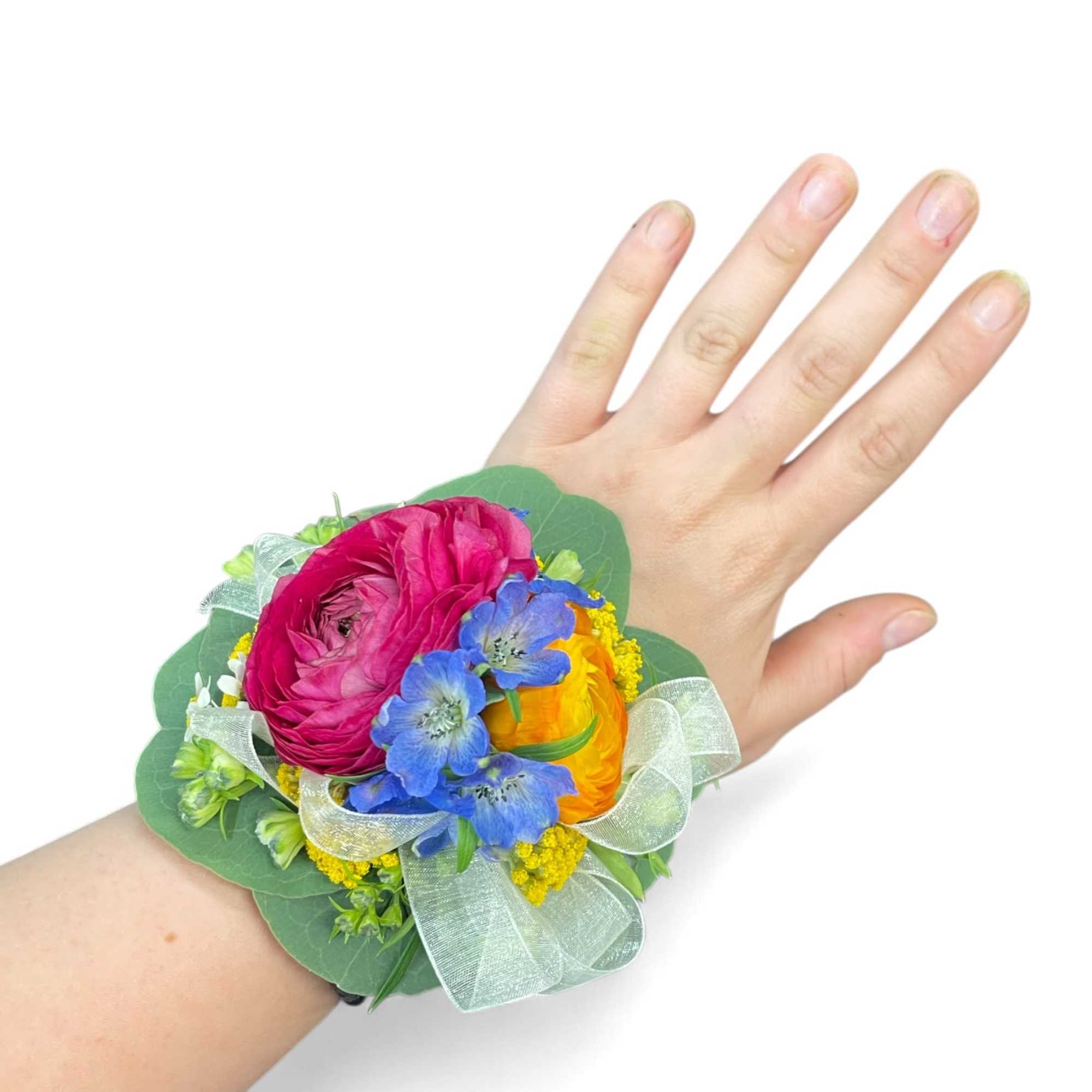 Colorful wrist corsage with pink, yellow, and blue flowers