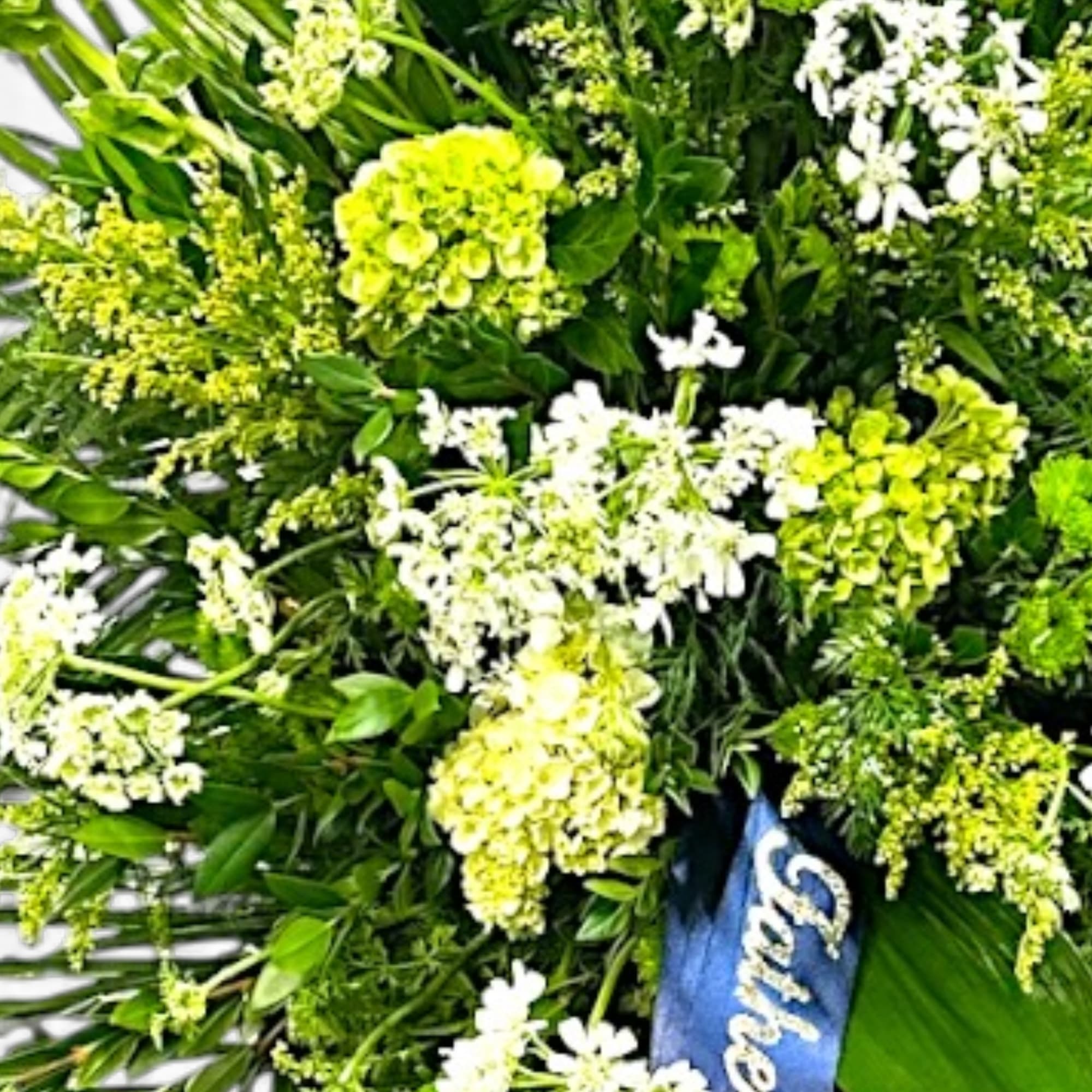 A serene tribute, "Green Fields" features lush greenery and delicate white blooms, photo 2 of 2