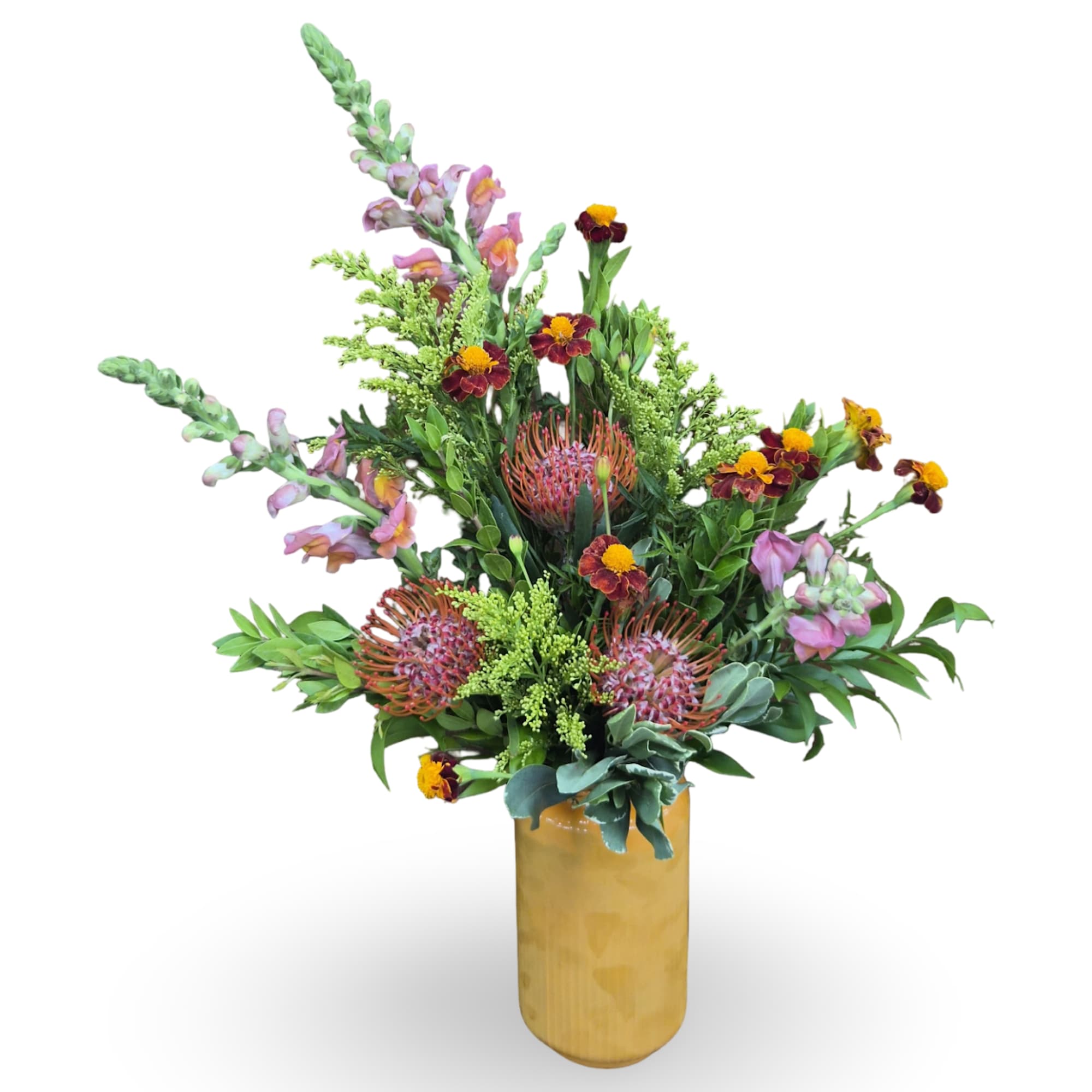 Mixed bouquet with pink snapdragons and burgundy pincushion blooms in a gold vase