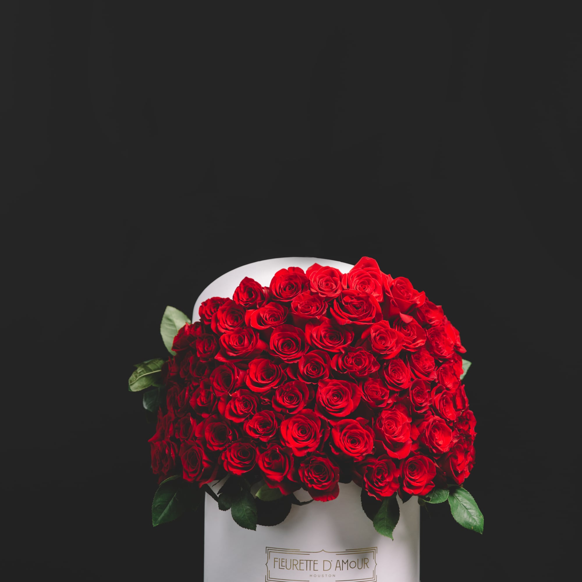 Large bouquet of red roses in a white hat box