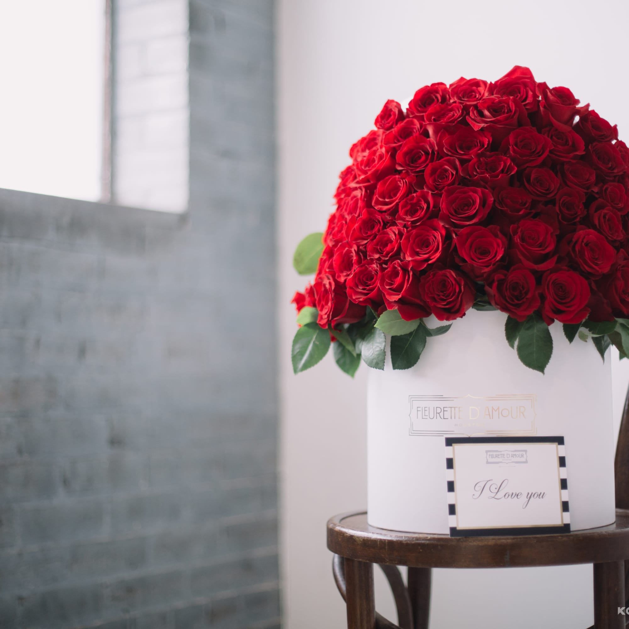 Large dome of red roses in a white hatbox with a small card
