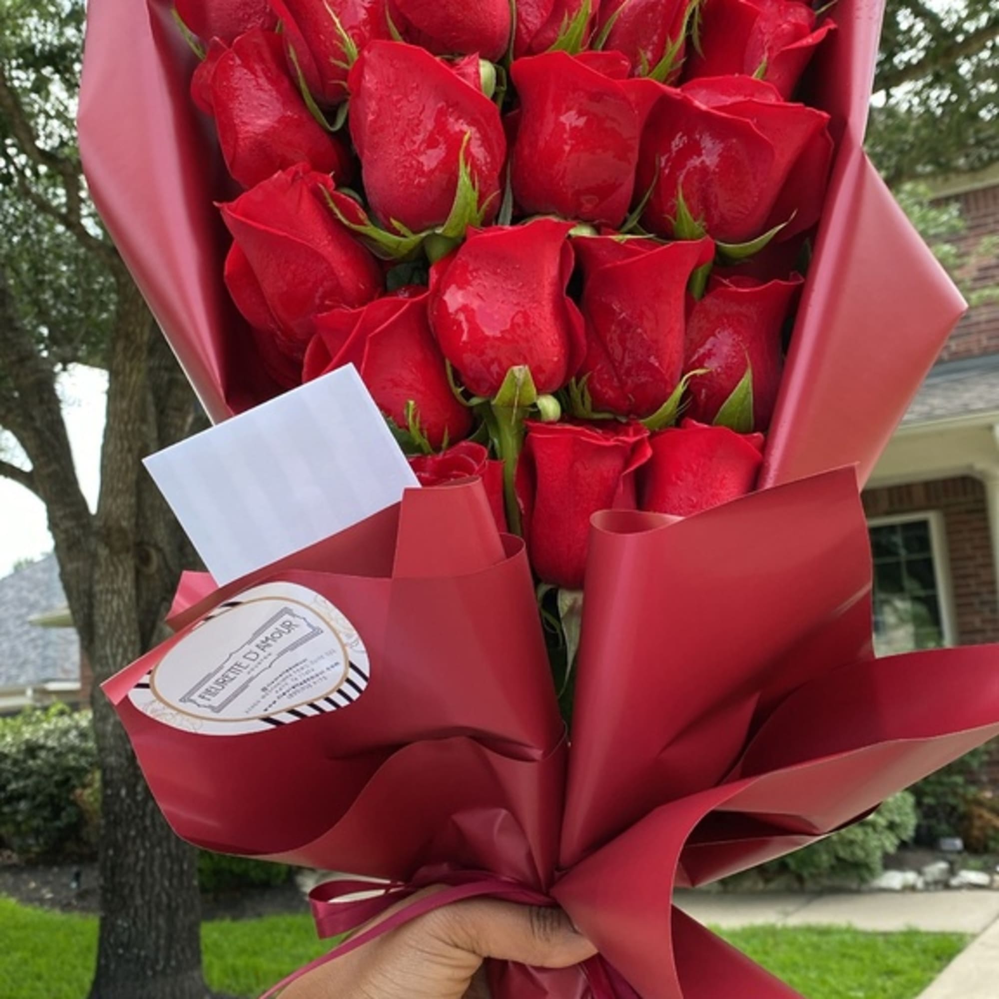 Bouquet of red roses wrapped in burgundy paper