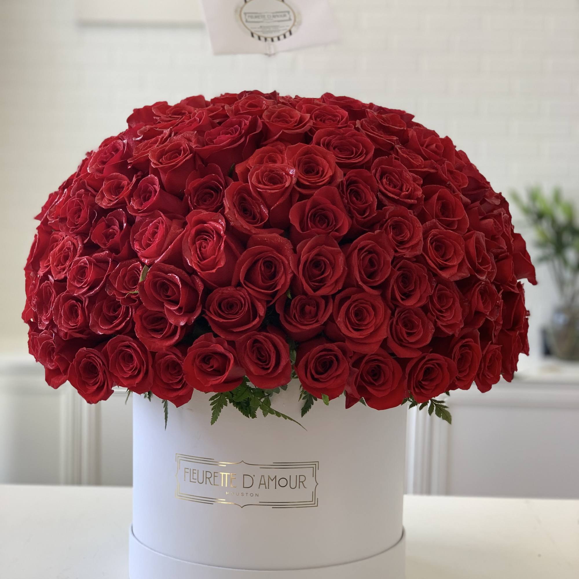 Large dome of red roses in a white hat box
