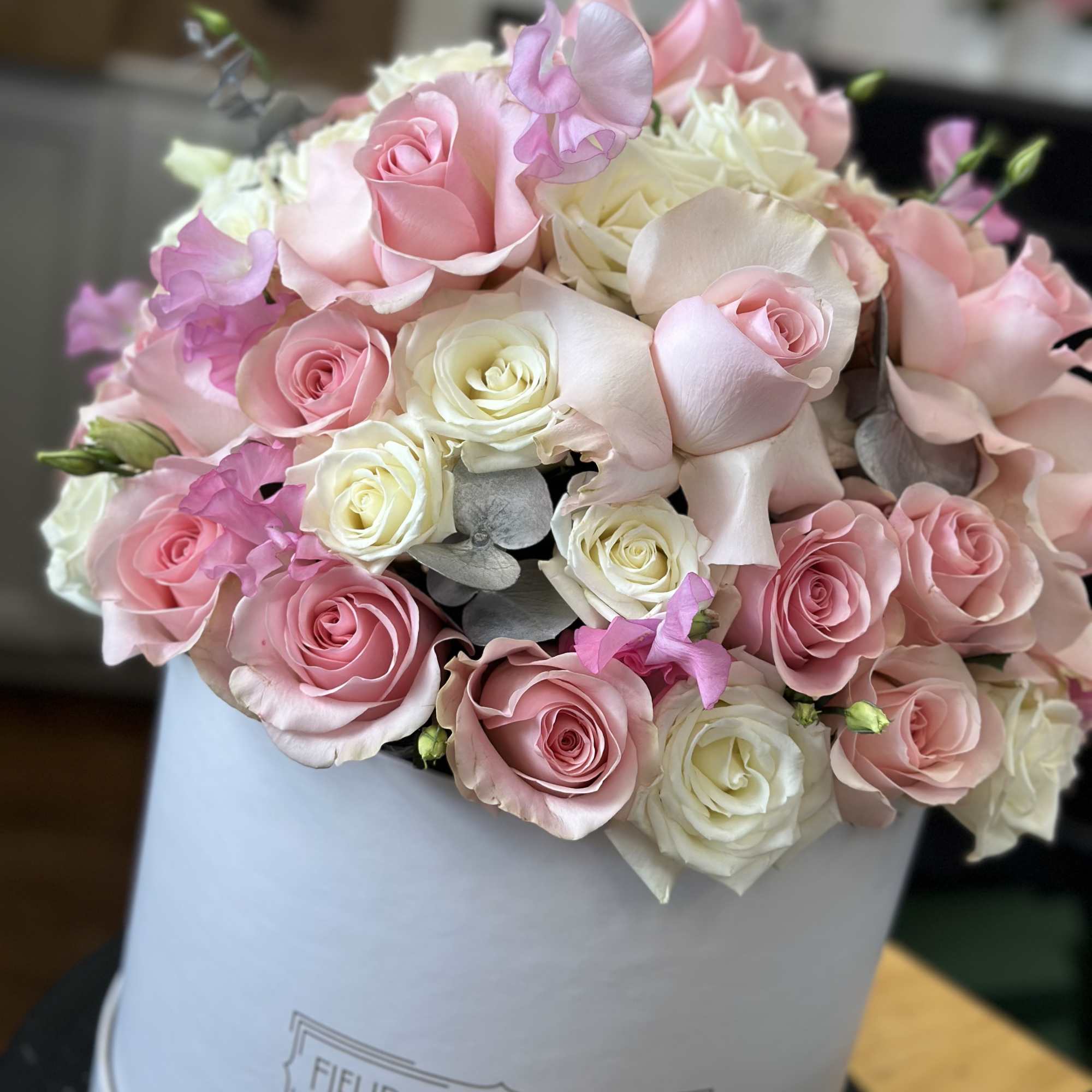 Pink and white rose bouquet in a white hat box
