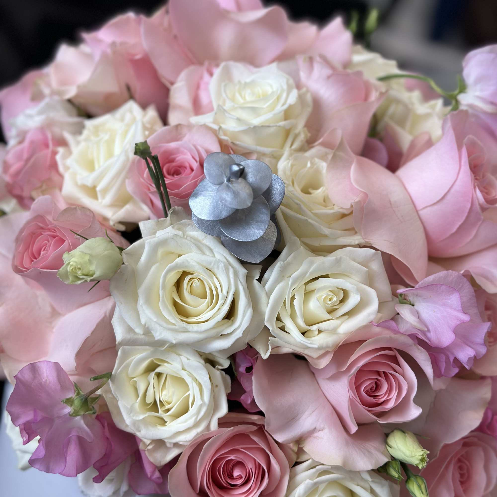 Bouquet of pink and white roses with pale pink petals